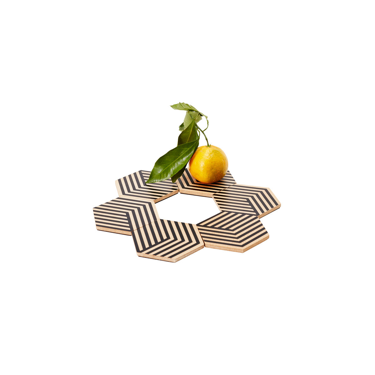 Areaware Table tiles optical black coasters in flower pattern with lemon on top on white background