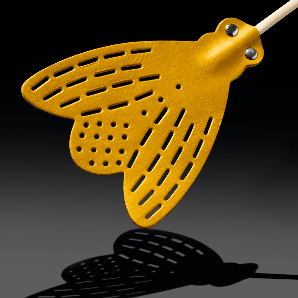 Close up of Essey fly-fly brown swatter head on angle on black background
