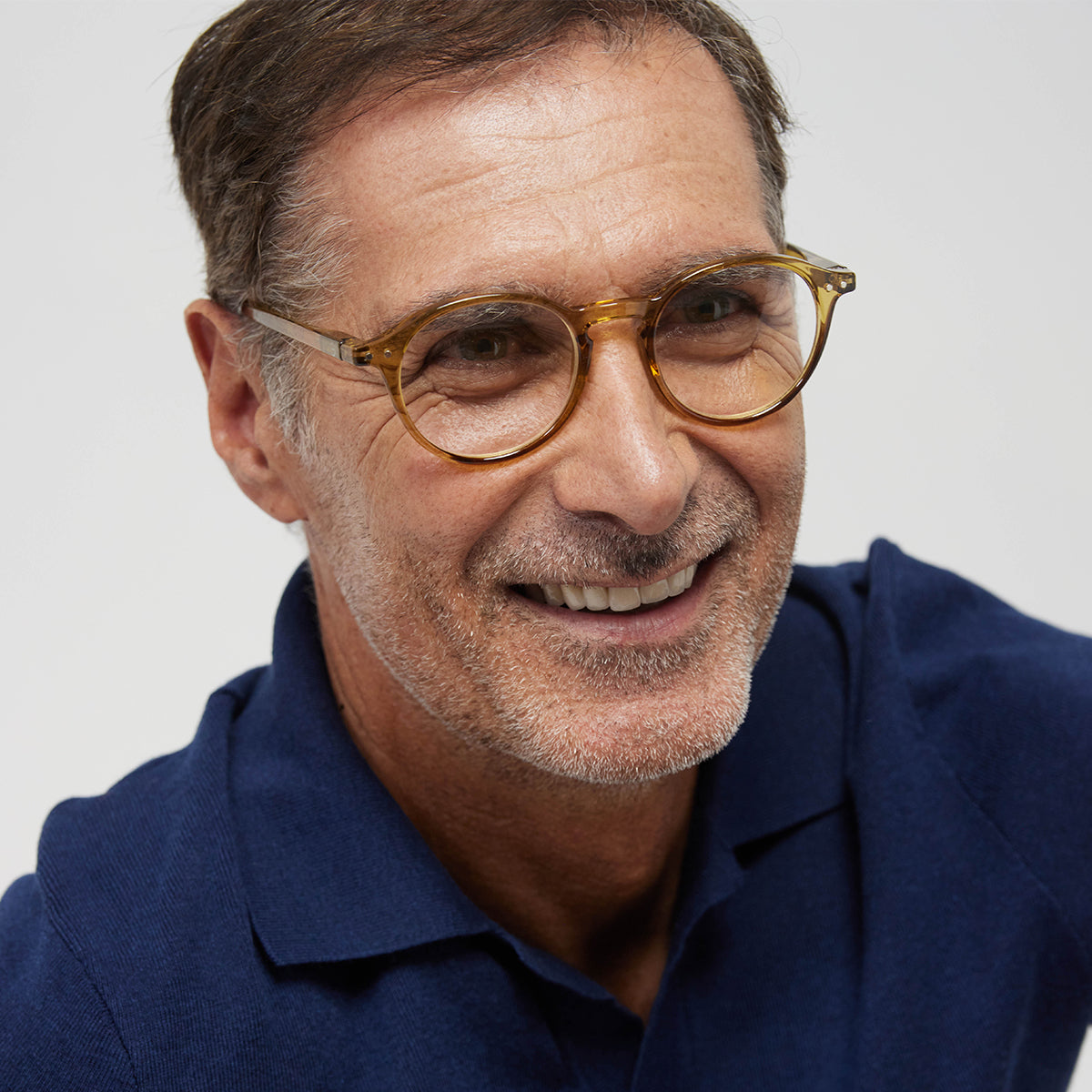 Man wearing Izipizi shape d golden green reading glasses with navy tshirt