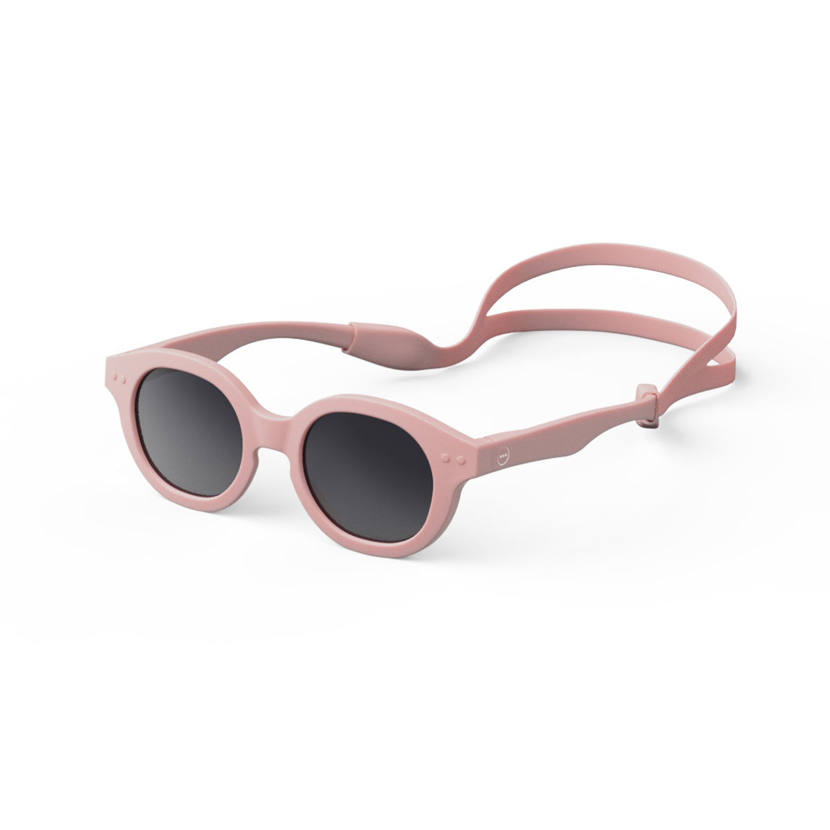 Izipizi kids sunglasses shape c pastel pink on an angle with silicone head strap on white background