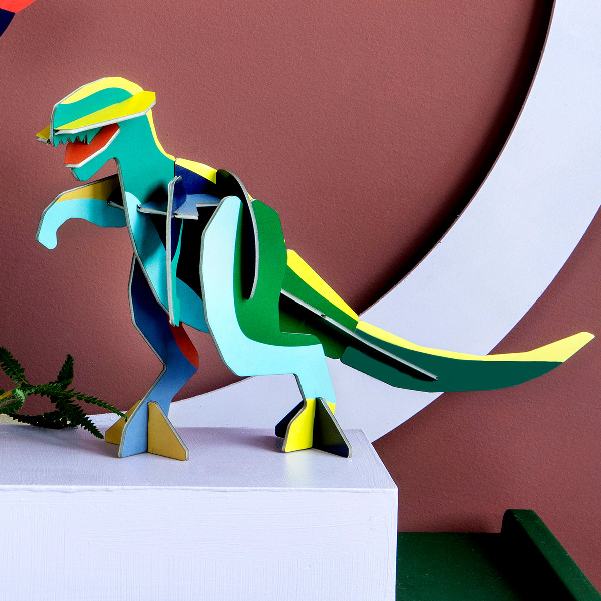 Studio Roof A4 creative play card t-rex standing on a pale blue box in front of brown background