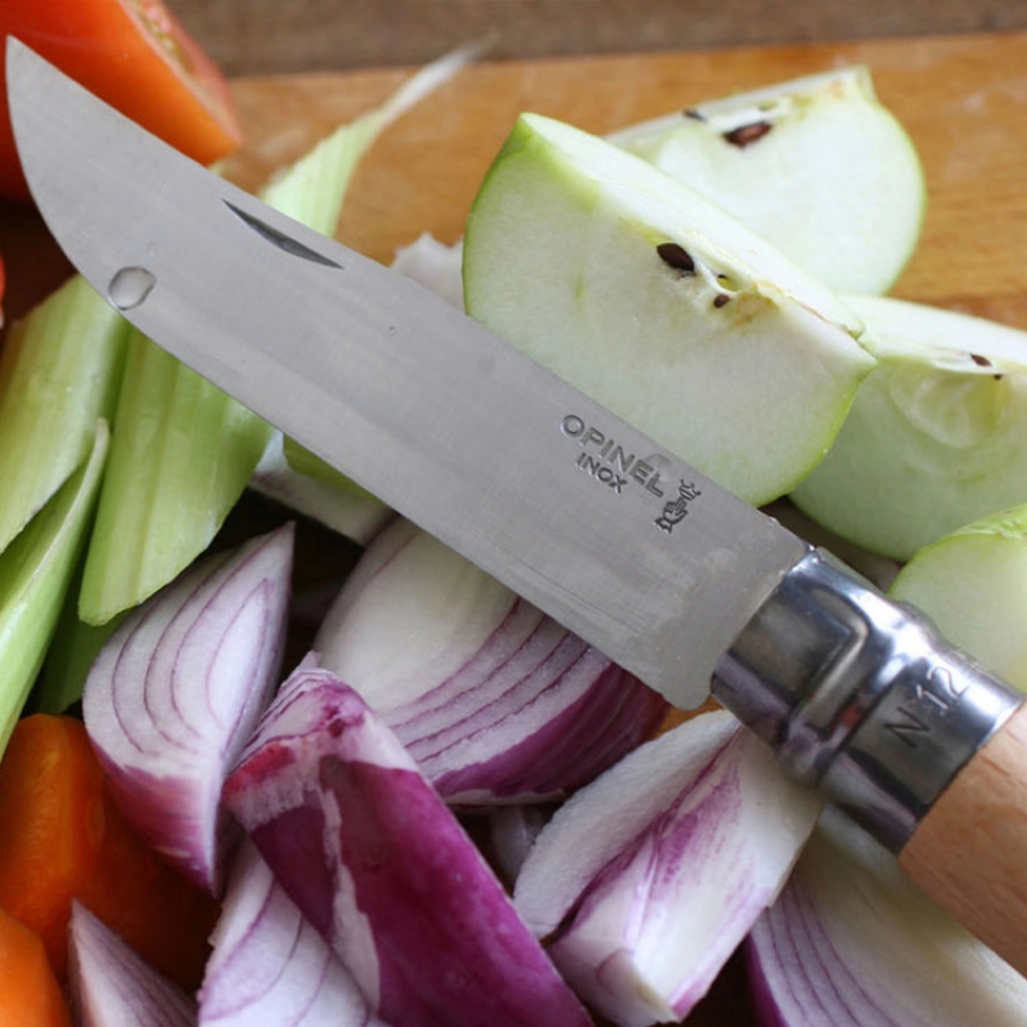 Opinel Traditional Folding Knife No12 Carbon Steel Beech on cheese board with various cheeses and fruits