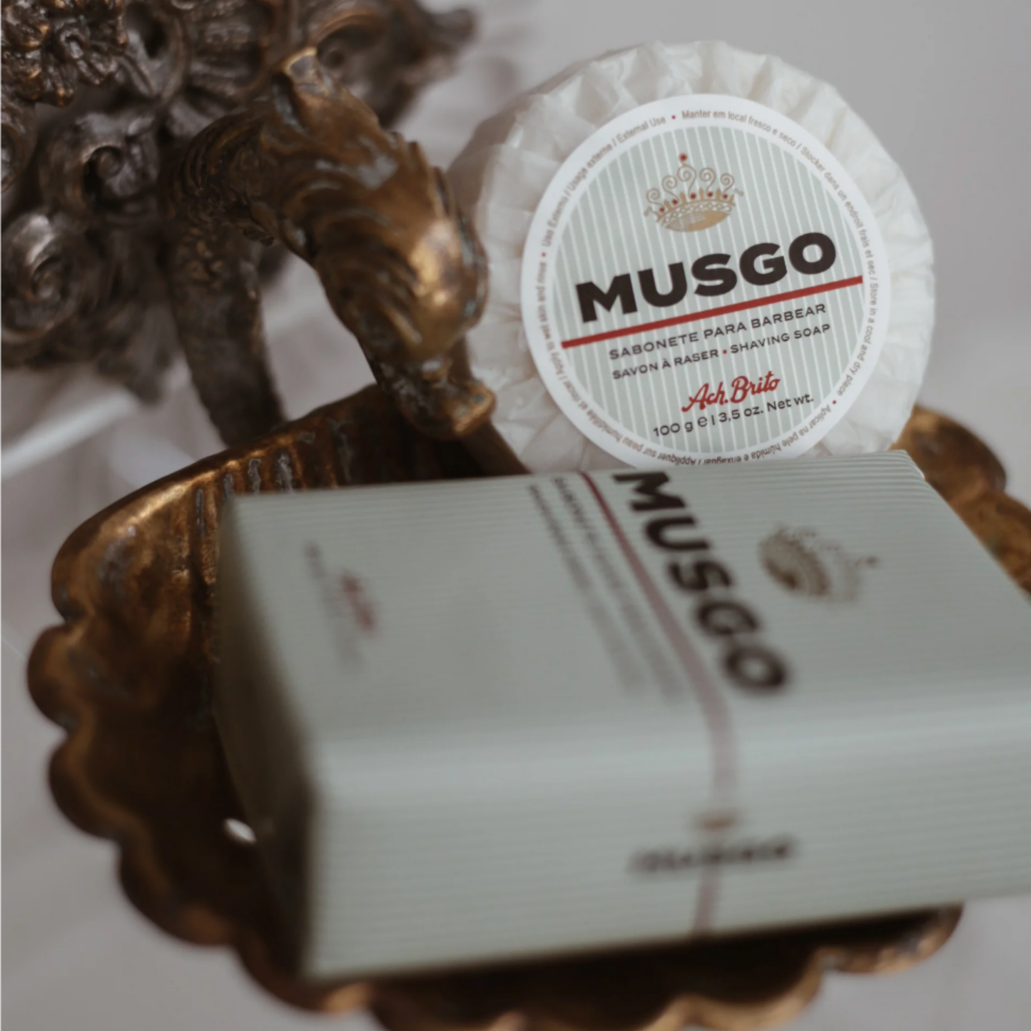 Ach Brito Musgo shaving sopa 160g in packaging wrapper on ornate brass soap dish