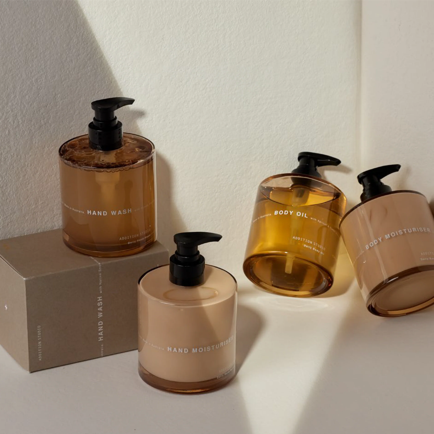 Assorted Addition Studios body care products including body oil