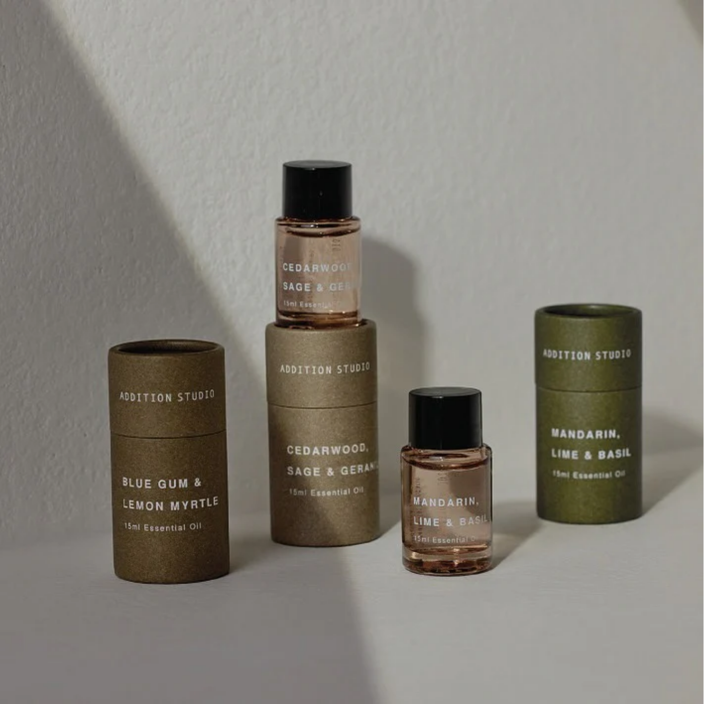 Assorted Addition Studios essential oils stacked together