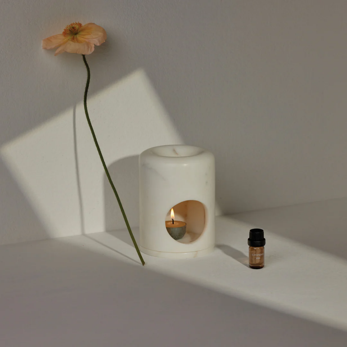 Addition Studios oil burner styled with flower and tea light candle