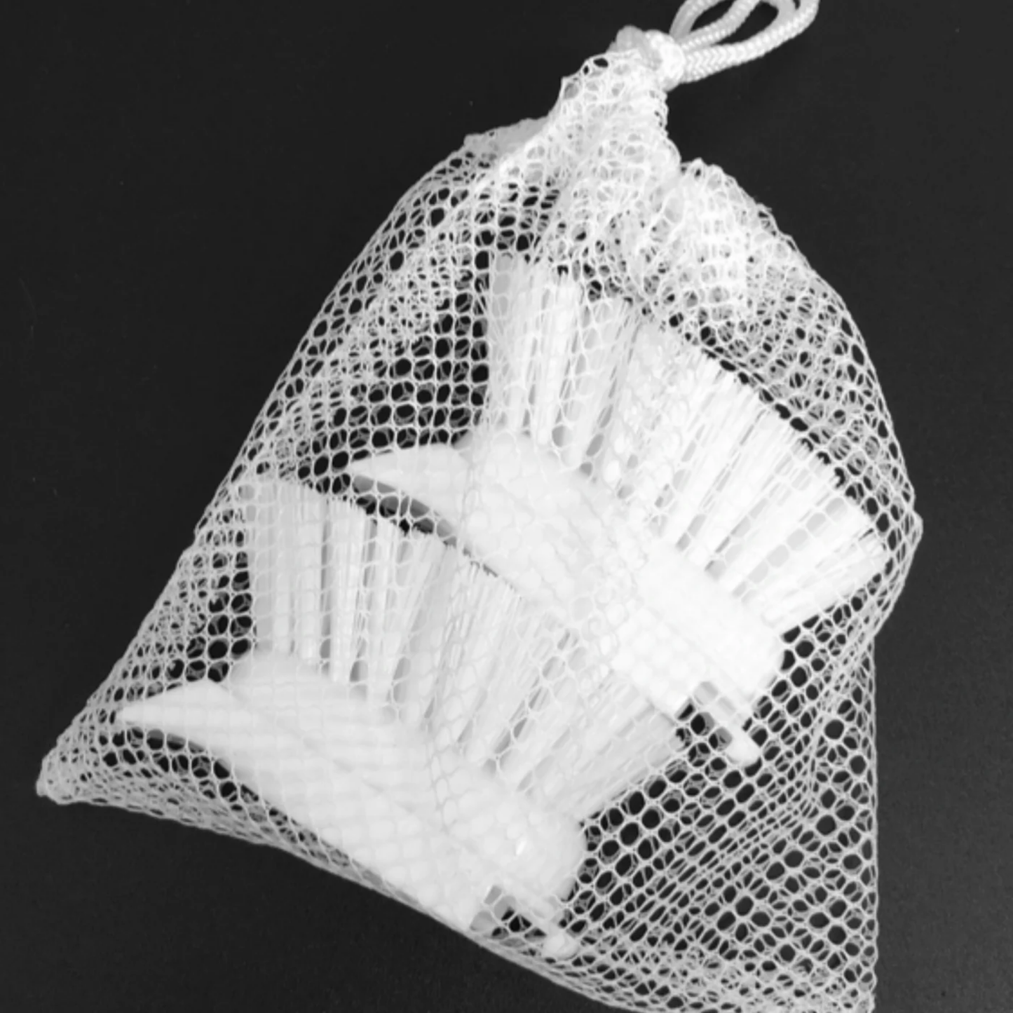 Barkly Basics dish stick brush refill in mesh net packaging on black background