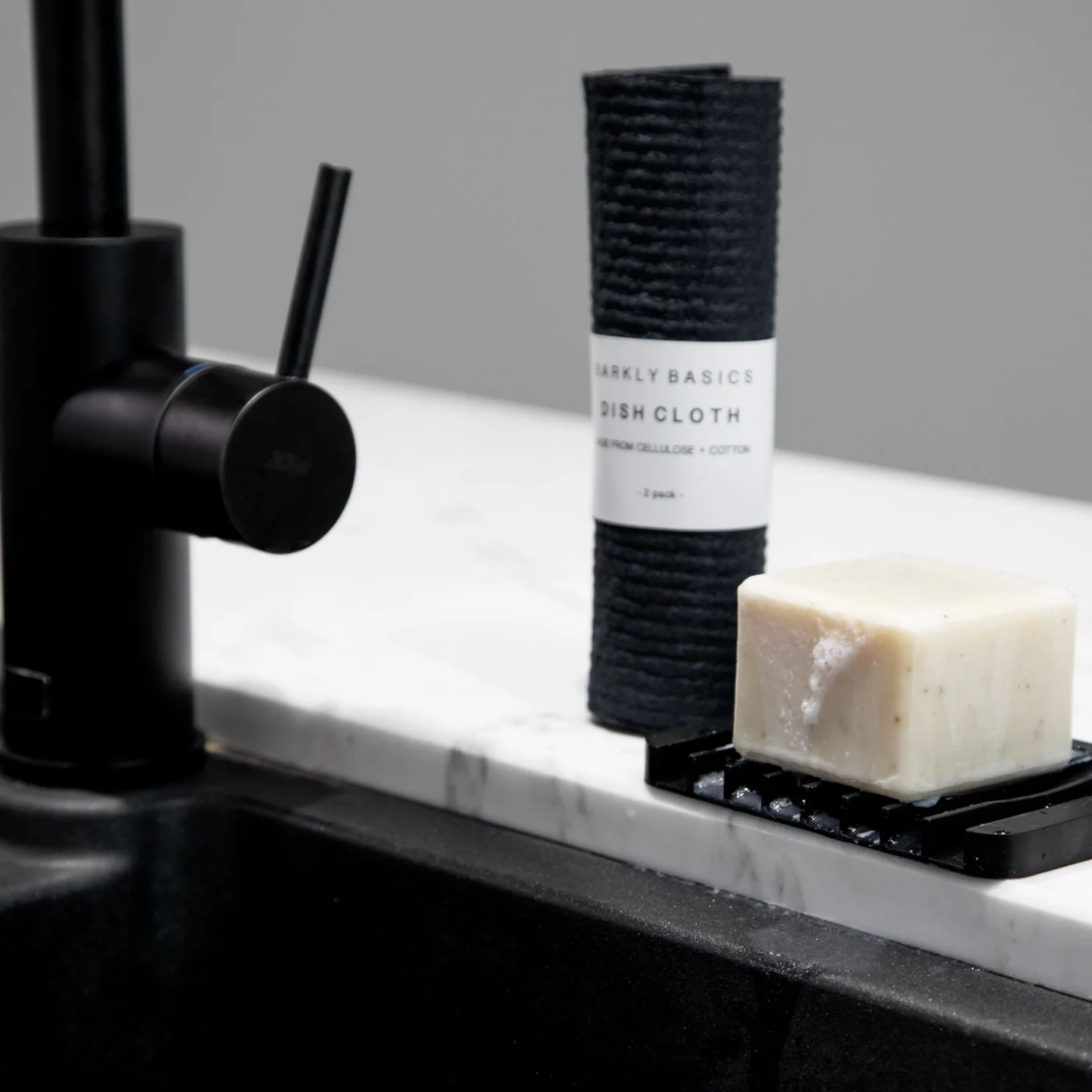 Barkly Basics Swedish dish cloth 2 pack rolled up in packaging on display near kitchen sink with soap