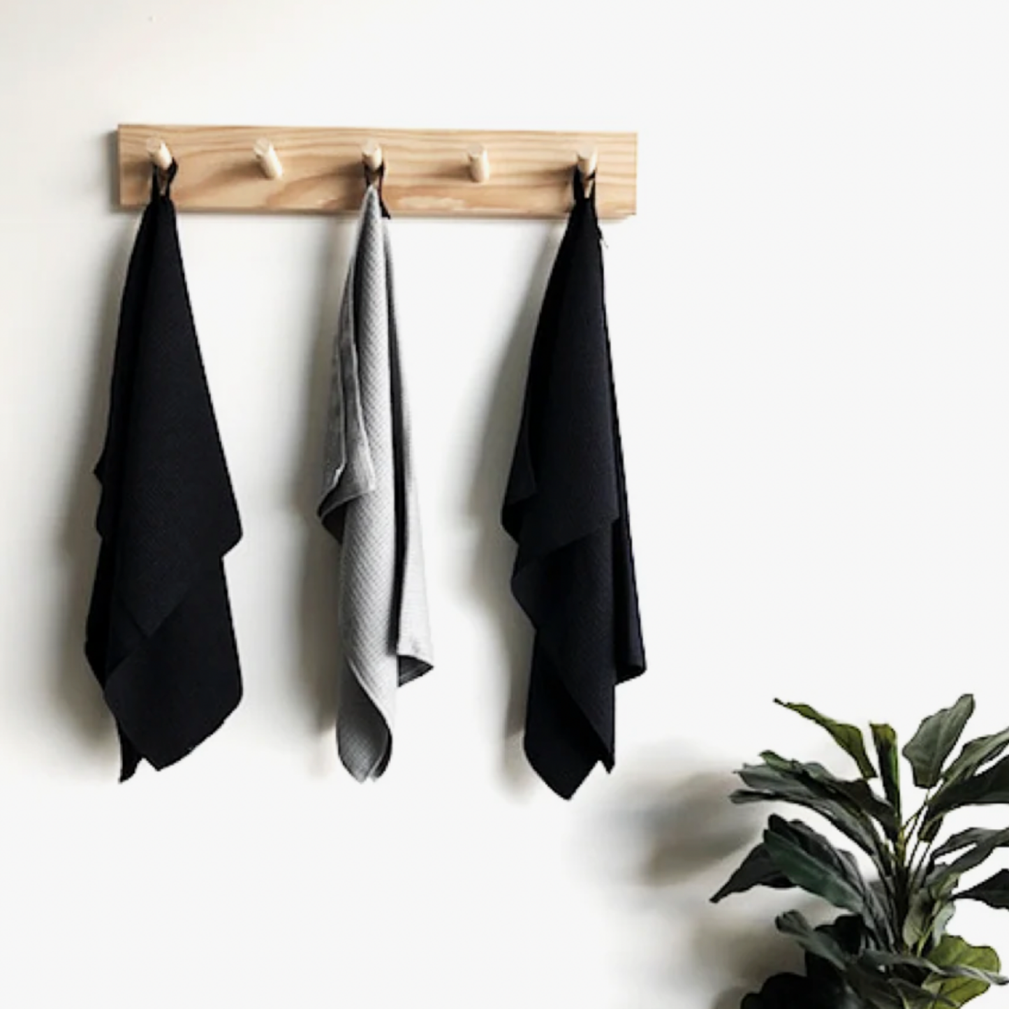 Barkly Basics microfibre towel black on display in hanging rack with other microfibre towels