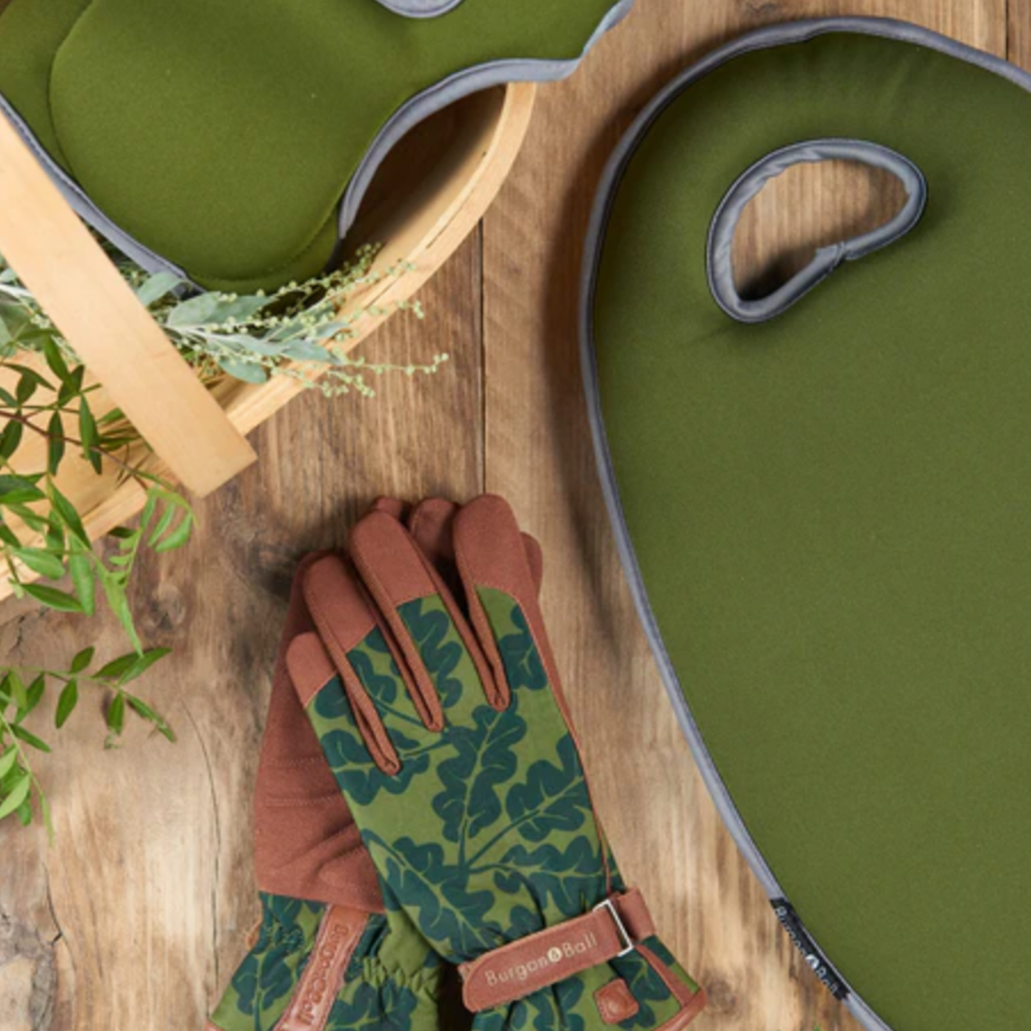 Burgon & Ball gloves on wooden table with flowers and basket