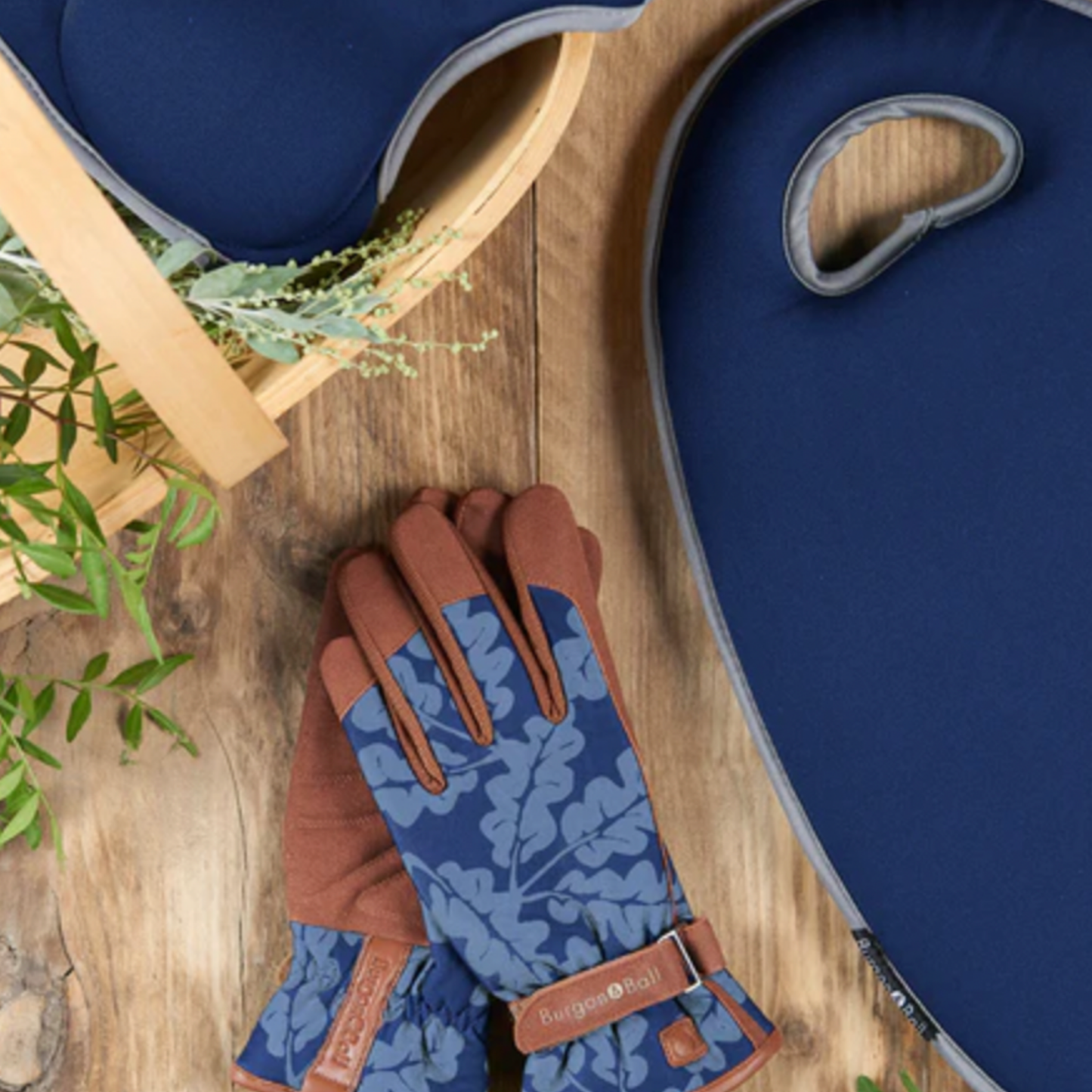 Burgon & Ball gloves on wooden table with flowers and basket