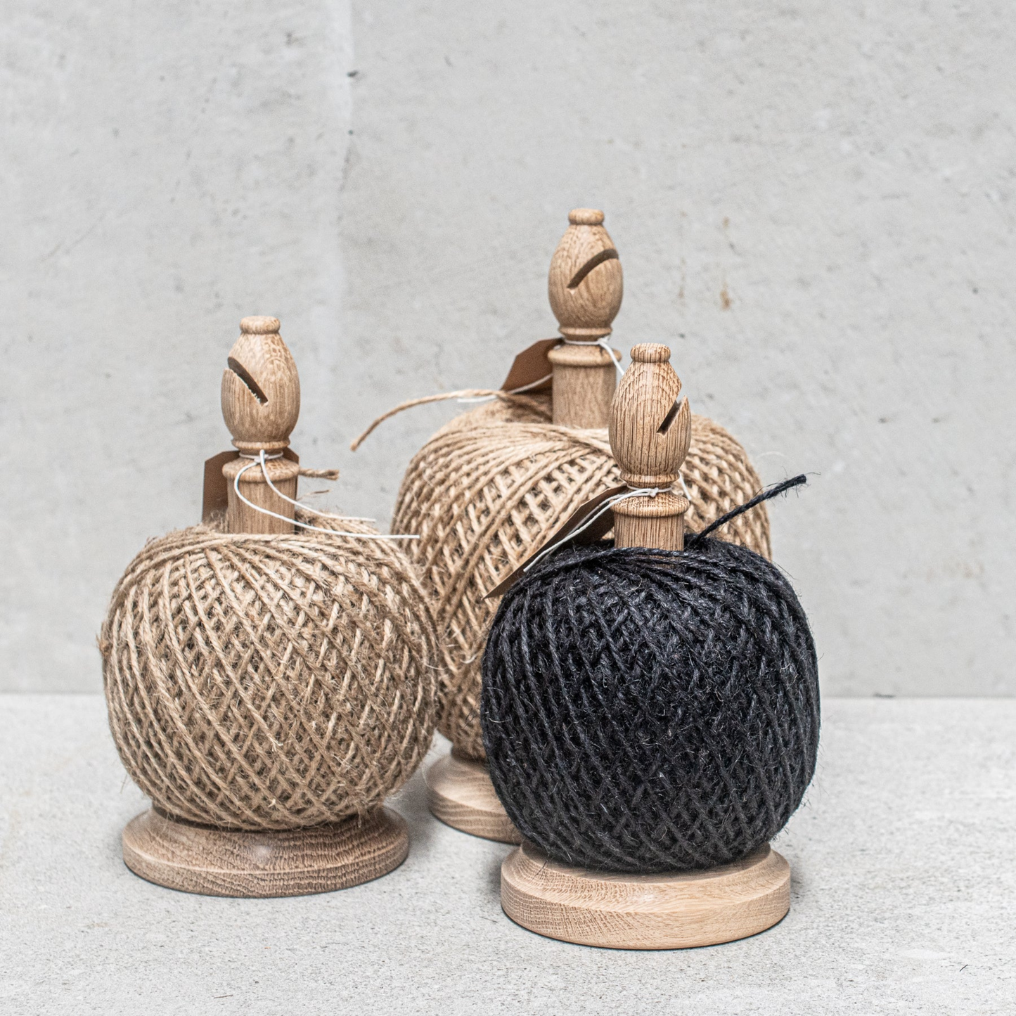 Twine stand with cutter natural large front view on concrete table with other twine stands