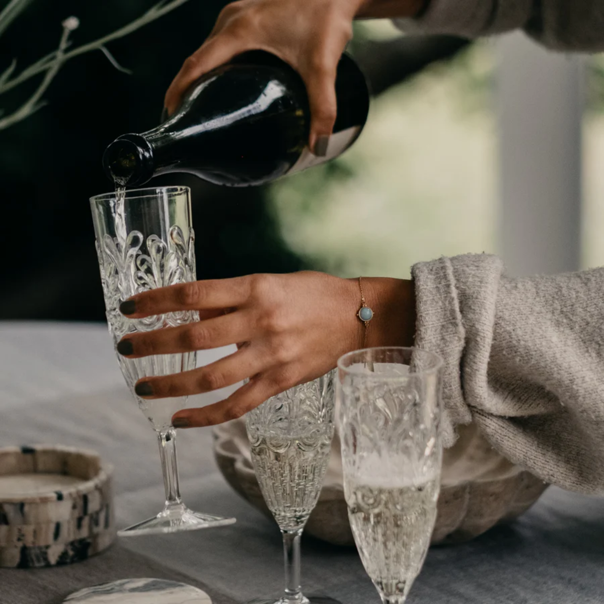 Wine poured on Fathom Clear acrylic champagne flute with elegant embossed detailing, glass-like clarity, and shatter-resistant BPA-free material.