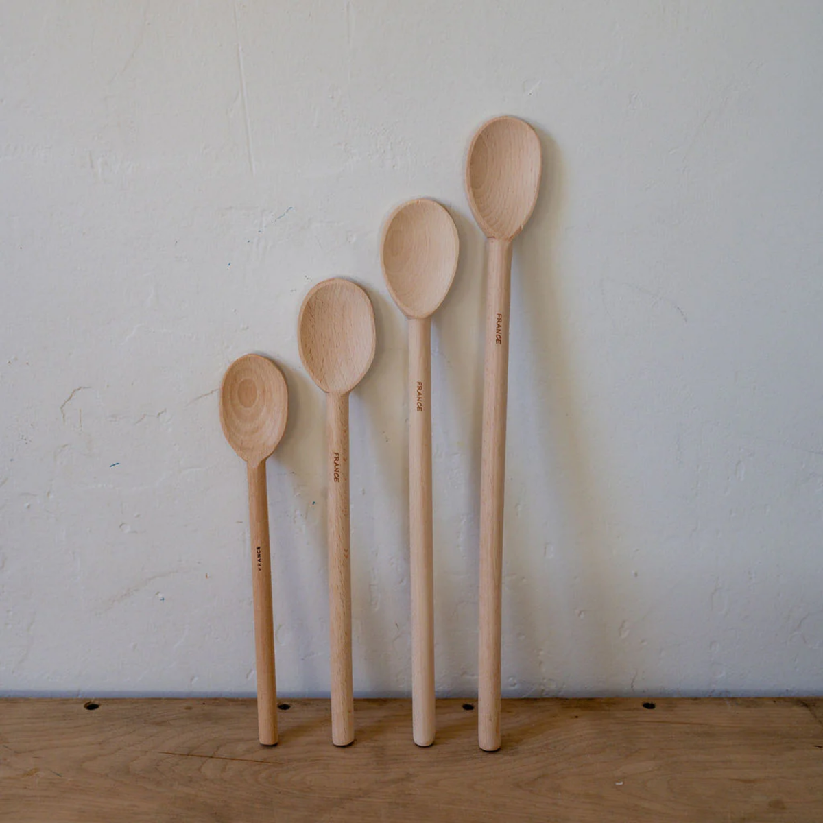 Front view of assorted wooden spoons 30cm on wooden table