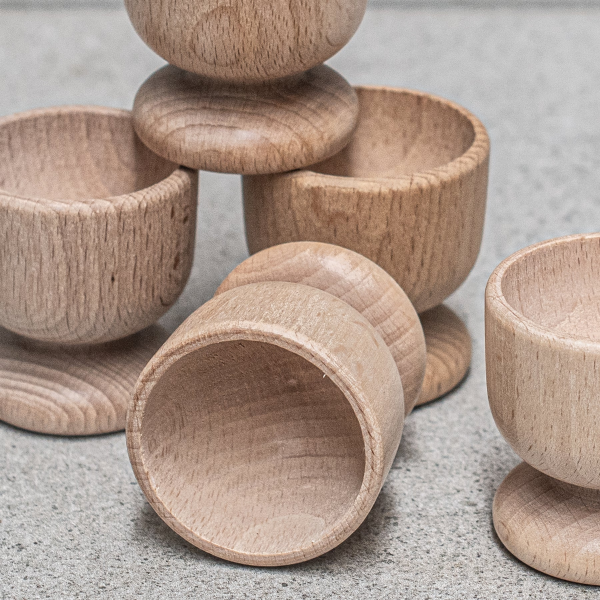 Close up Natural FSC beechwood egg cup by Heaven In Earth, a charming and practical piece that adds warmth and simplicity to your breakfast table.