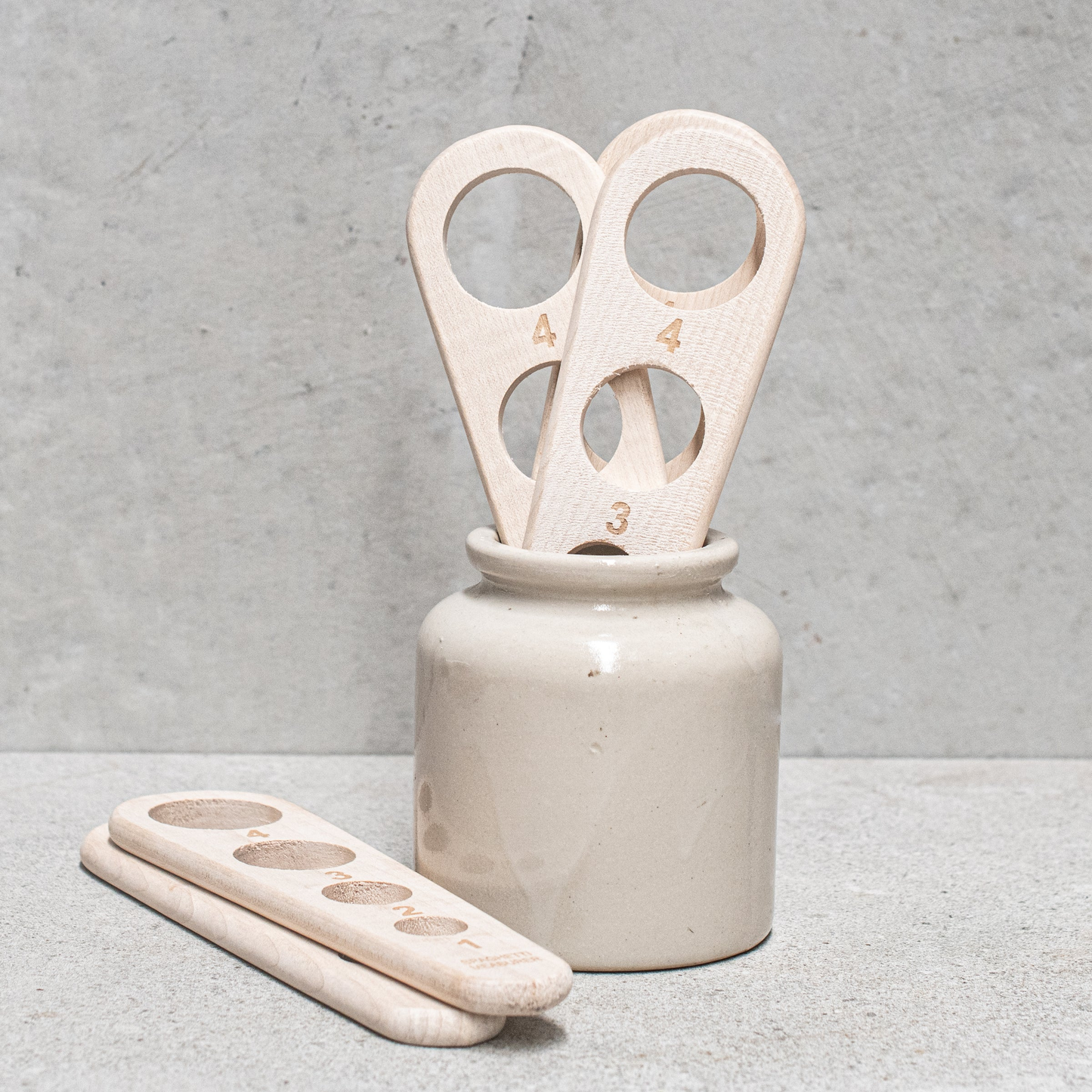 Various pasta meausing paddles on display in jar on countertop