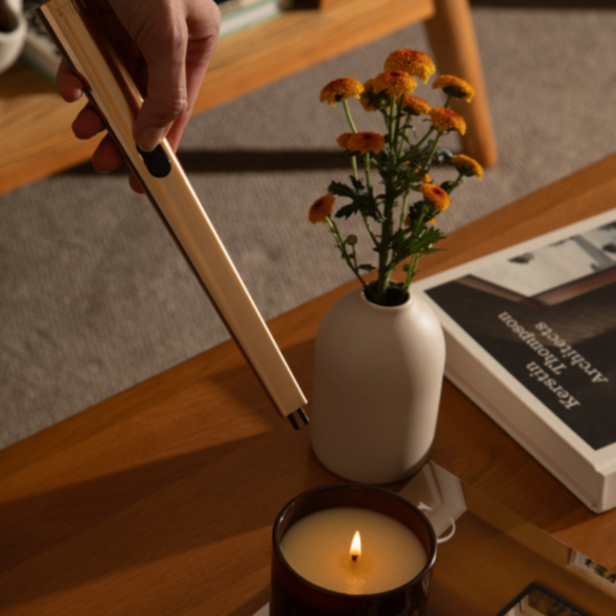 Flint rechargeable gold lighter lighting candle in livingroom setting