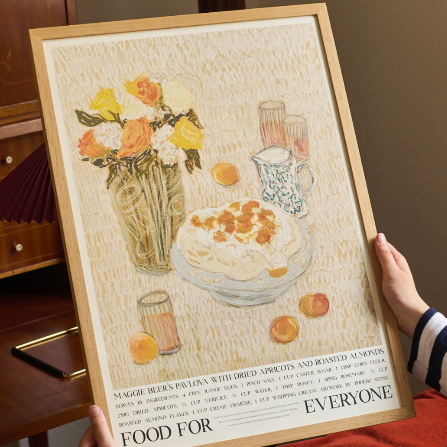 Woman holding Food For Everyone Maggie Beer Pavlova artwork A2 in frame