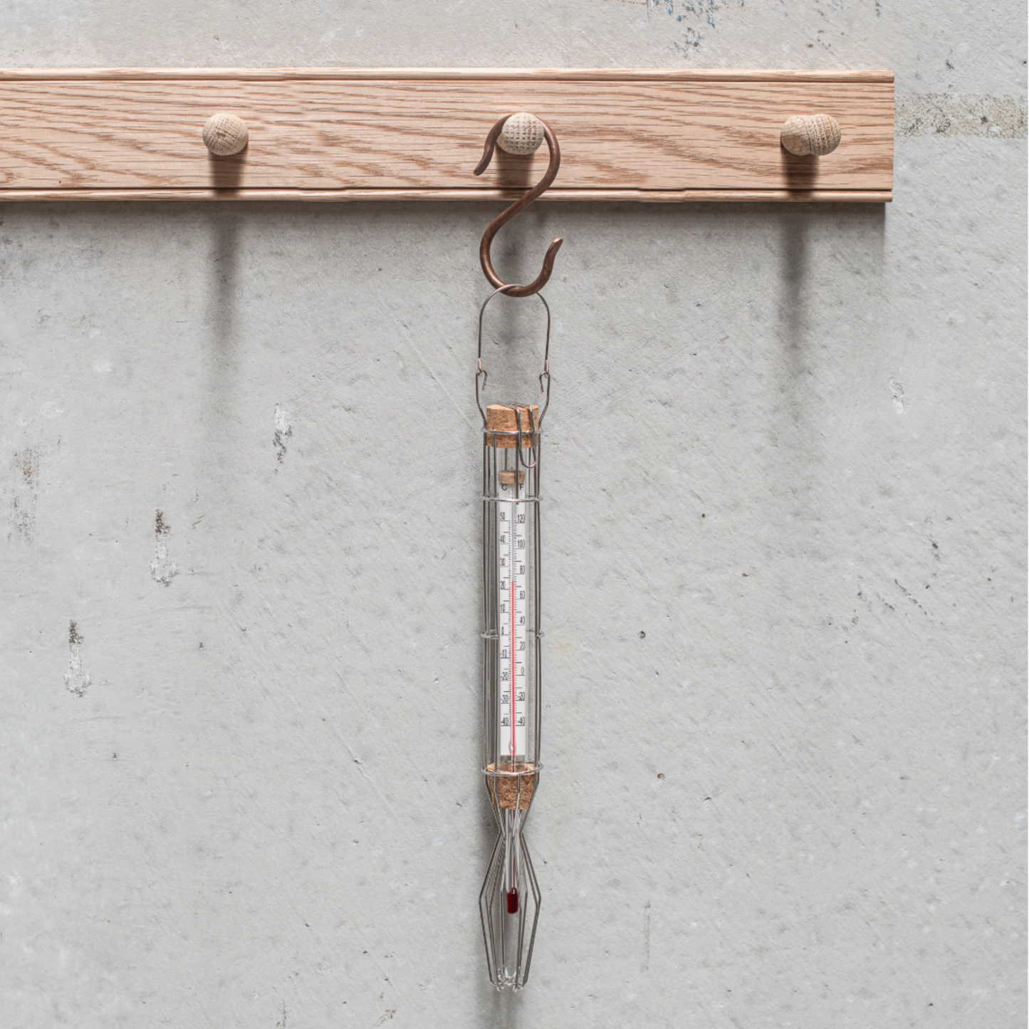 Heaven in Earth Garden Thermometer hanging on wooden pegs from copper hook