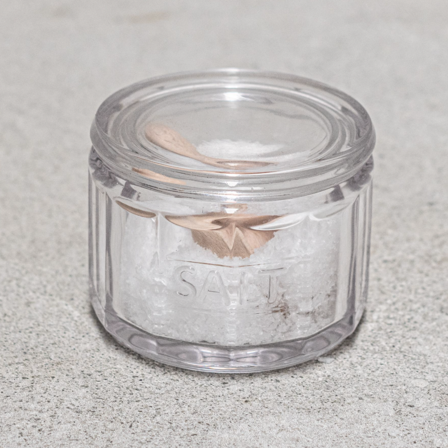 Heaven in Earth Glass Salt Pot & Wooden Scoop with salt and scoop in pot on concrete table with lid closed