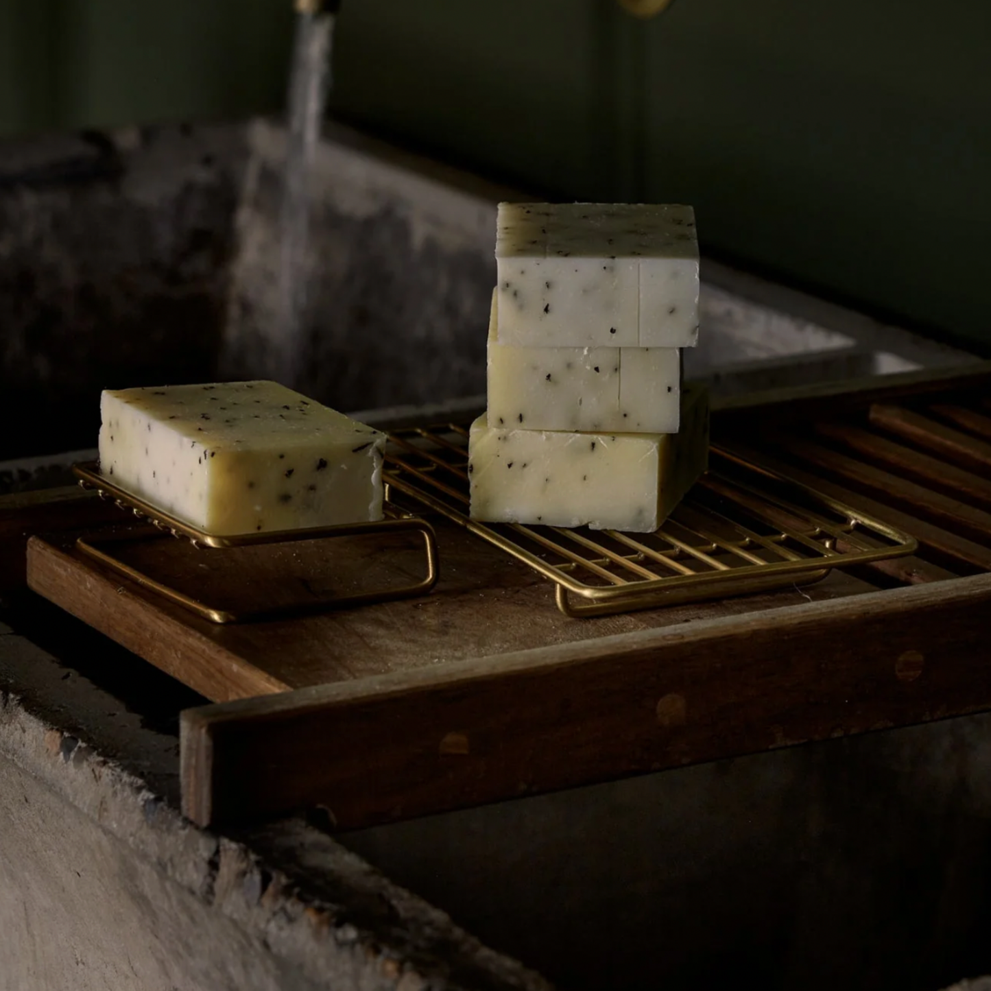 Herb Remedy Lemon Myrtle soap bars next to sink with running water