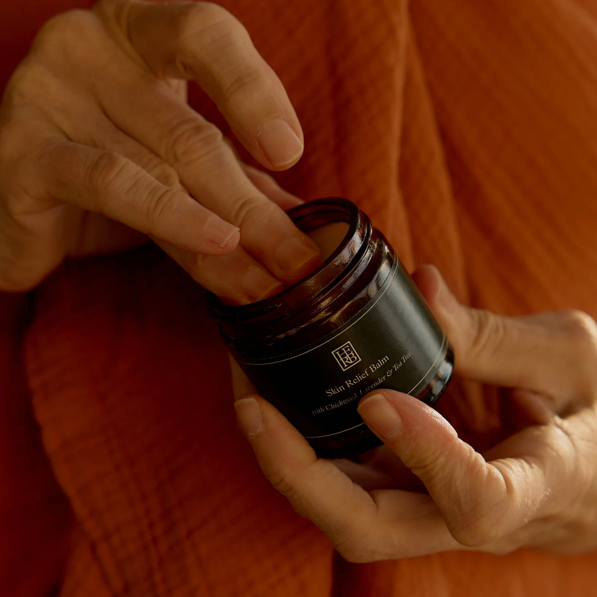 Applying the Herb Remedy Skin Relief Balm - Cooling natural balm for itchy, irritated skin - Infused with chickweed, calendula, lavender, and tea tree oils for soothing, anti-inflammatory, and antimicrobial relief - Made with extra virgin olive oil, beeswax, and vitamin E to calm rashes, insect bites, eczema, and redness - Gentle herbal balm for sensitive skin healing and daily skin comfort