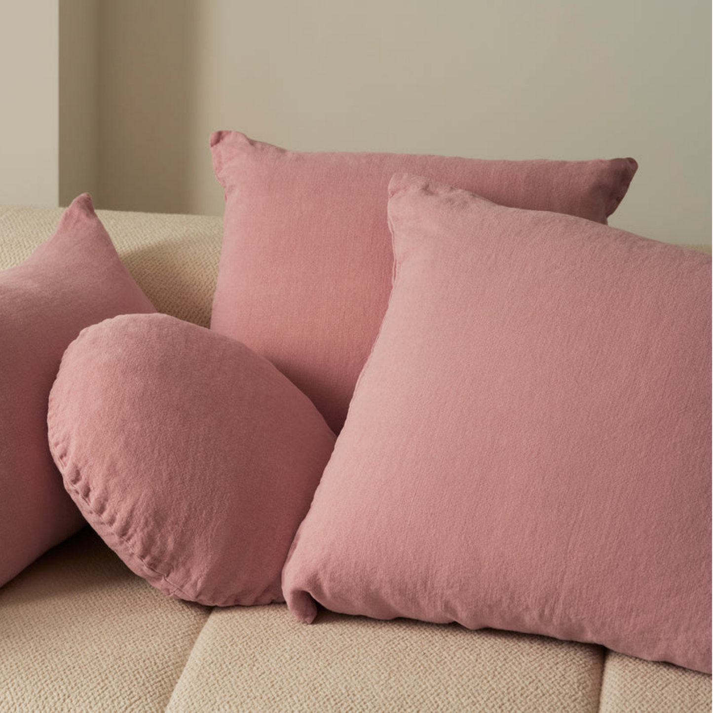 Hommey linen cushion blush on display on couch with linen blush range
