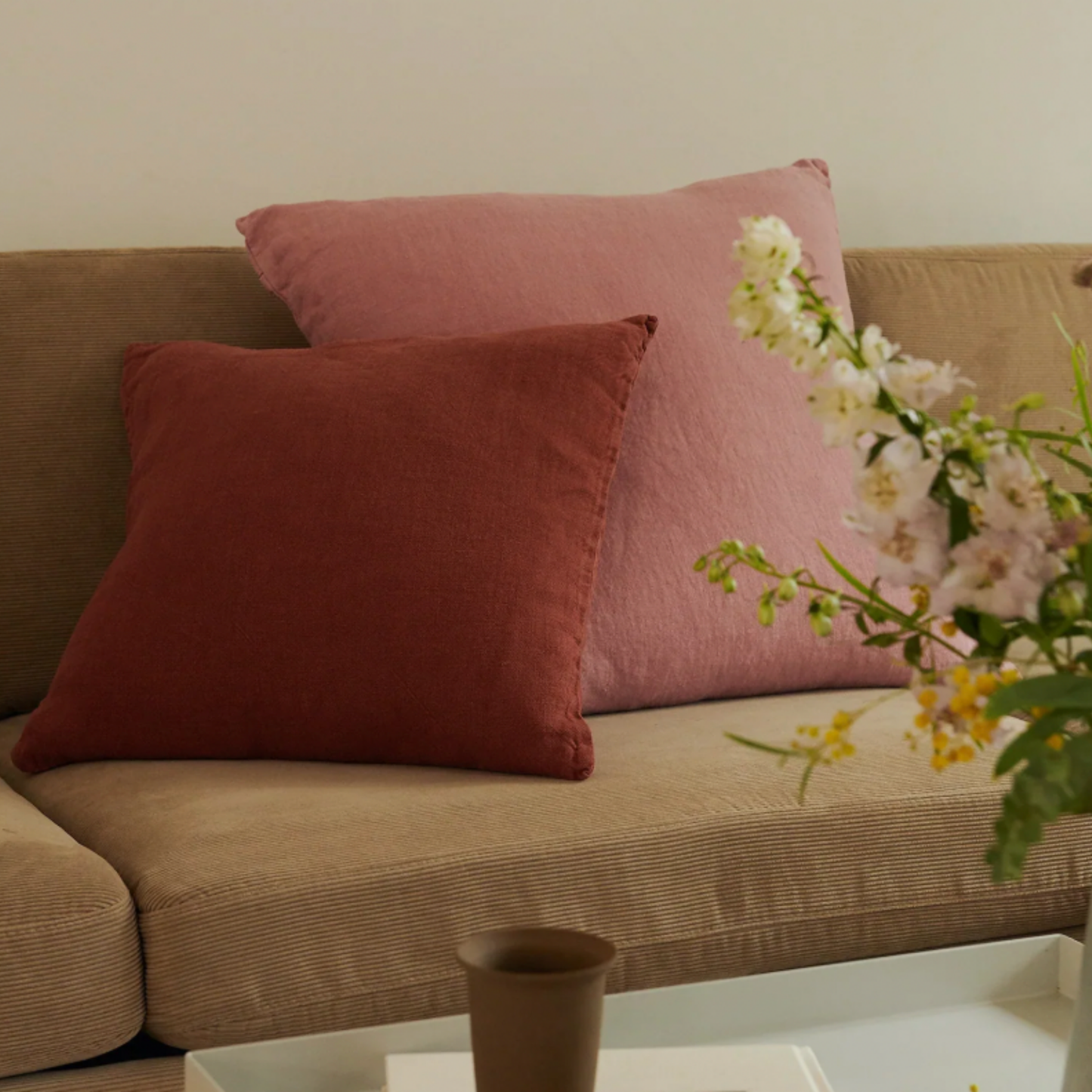 Hommey linen cushion rust on couch