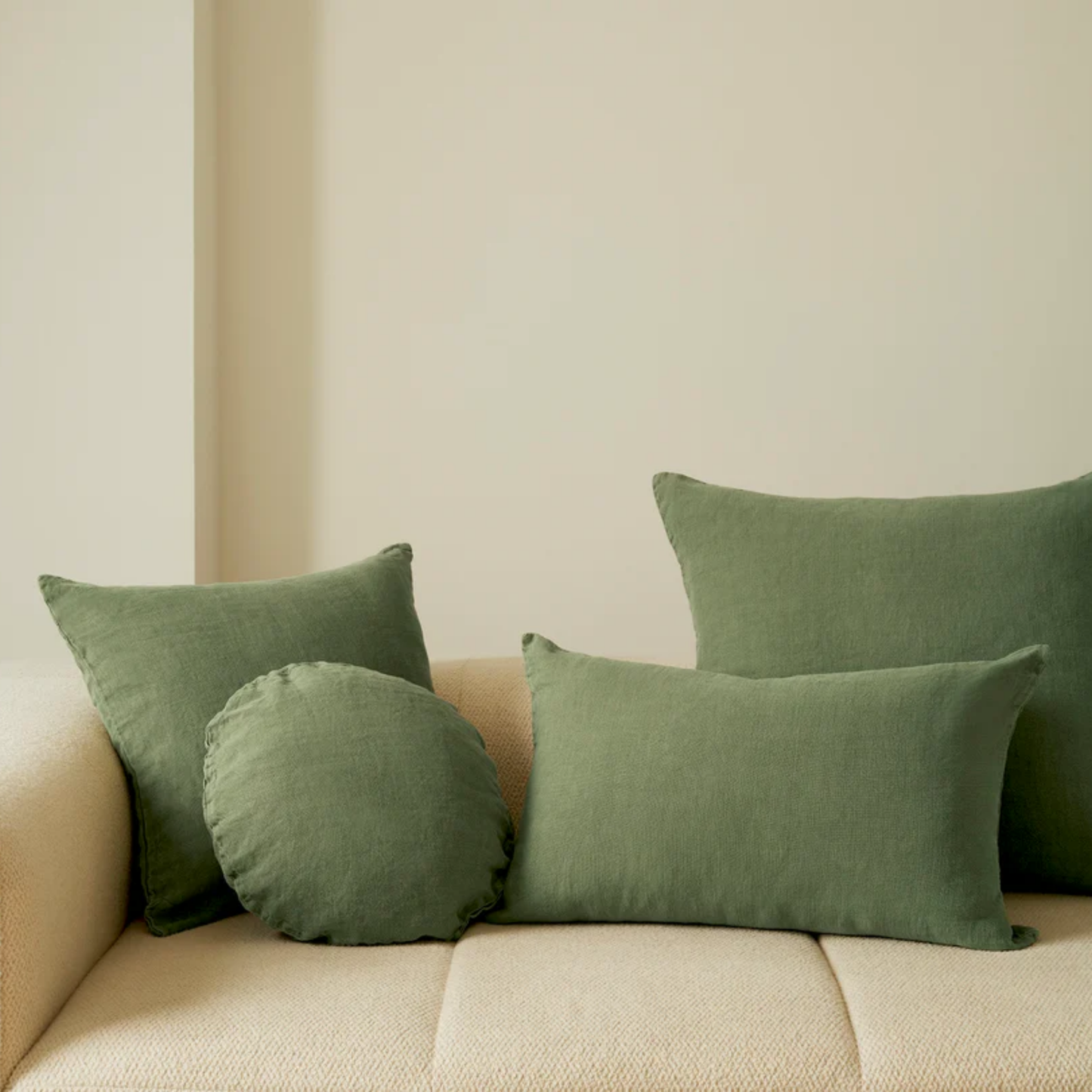 Hommey linen cushion moss range on display on couch