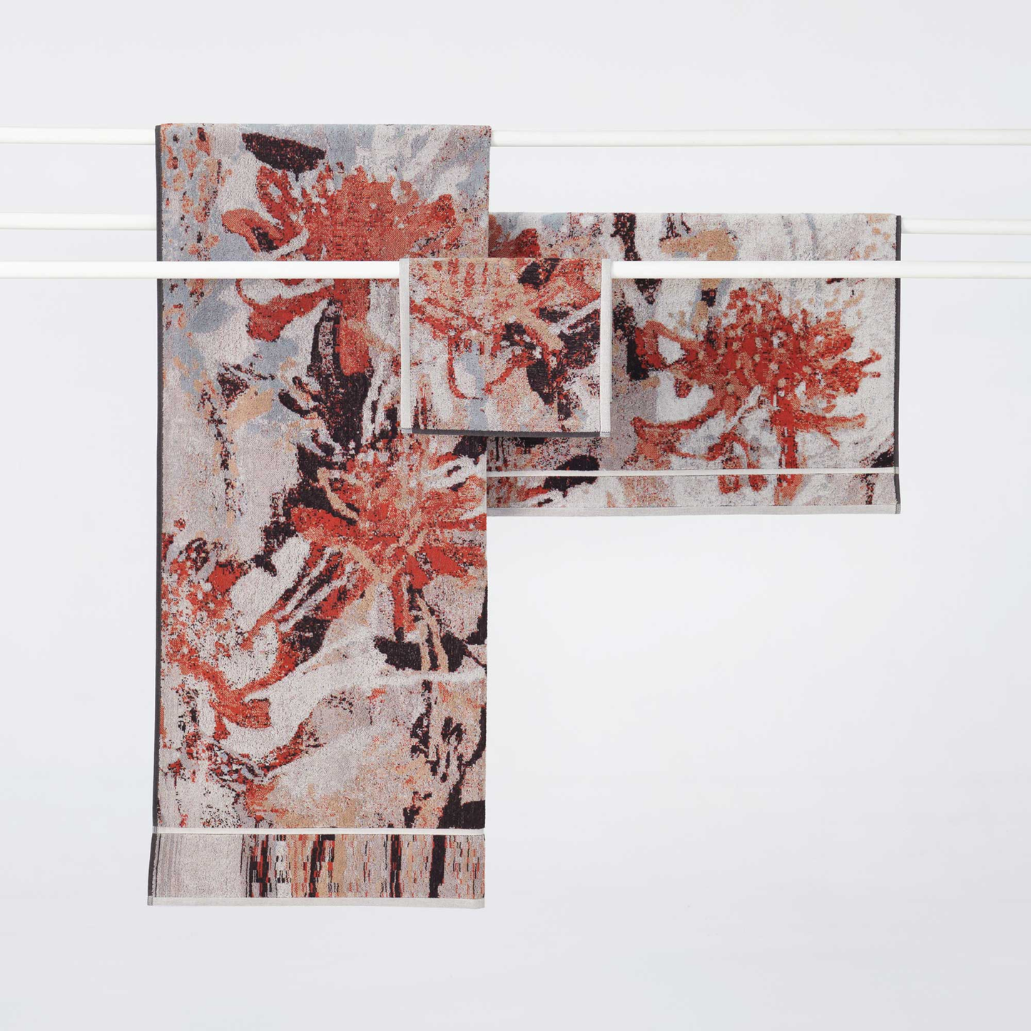 Showing the Ilford bath sheet, bath mat and the Innate Ilford Guest Towel 30cm x 50cm guest towel featuring an iconic Waratah floral design inspired by the Australian bush, made from 100% OEKO-TEX® certified cotton, showcasing an absorbent six-colour jacquard weave with rich texture and weight, responsibly woven in Portugal for everyday premium use.