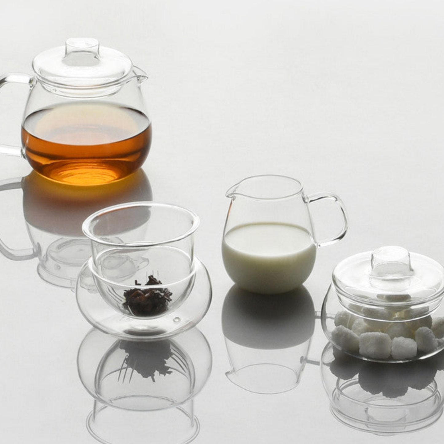 Stylish glass Kinto Unitea Milk Jug 180ml on display on table with Kinto glassware varietes serving tea