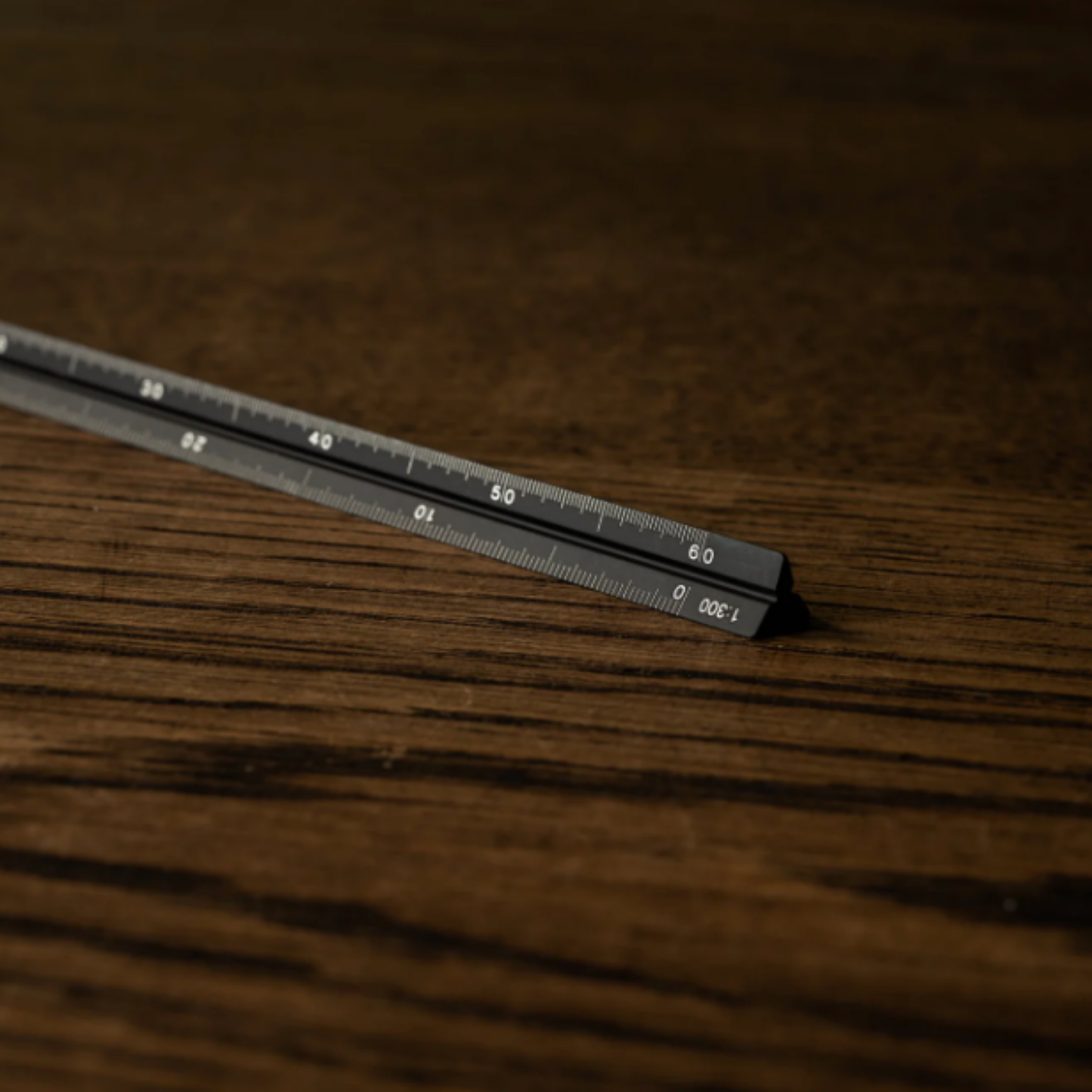 Close up of Penco black drafting scale on wooden table