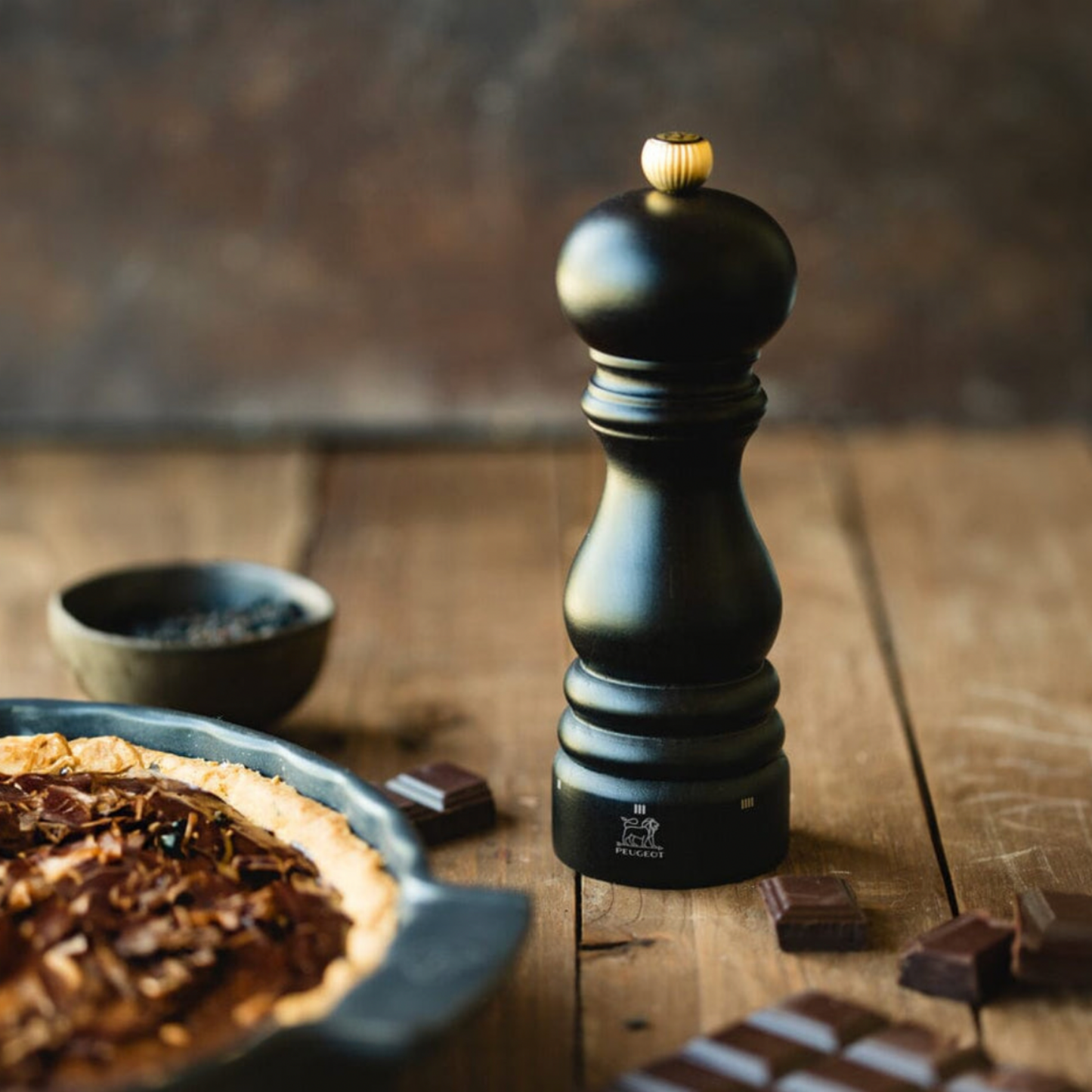 Peugeot Paris uSelect Salt Mill 18cm Chocolate on display on rustic wooden table next to chocolate tart