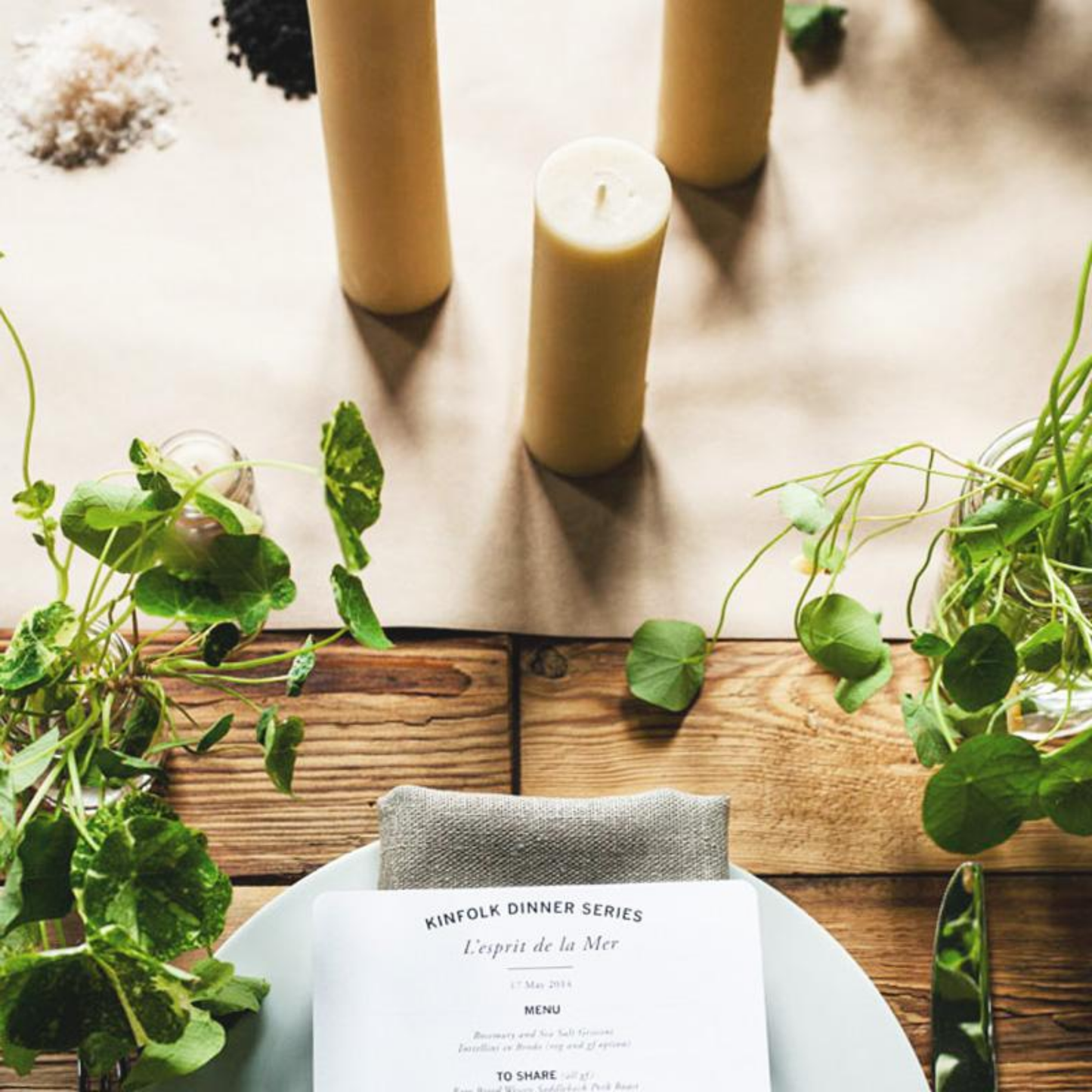 Queen Bee candle on table with setting and plants