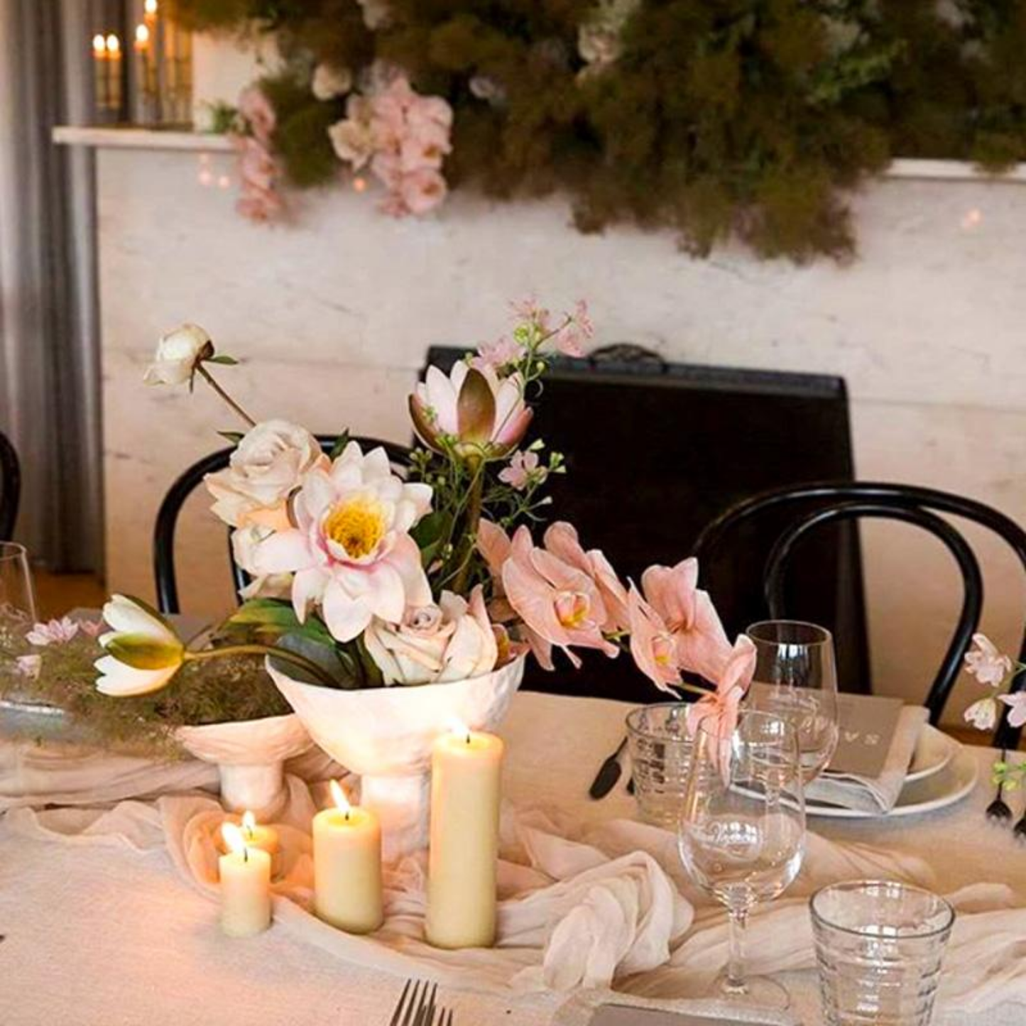 Table set with Queen Bee beeswax pillar candle 8cm in centre next to flowers