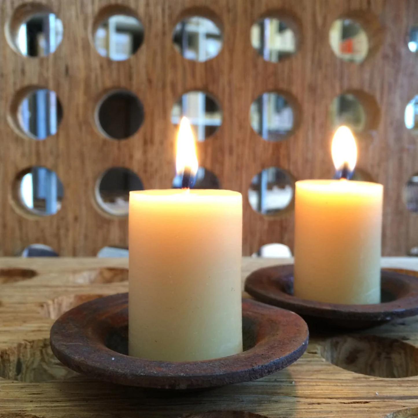 Queen Bee mini pillar candles in candle holder on wooden table