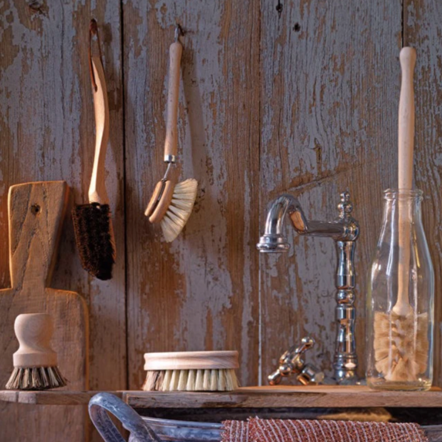 Redecker dish brush replacement head and base displayed hanging in kitchen with other Redecker products.