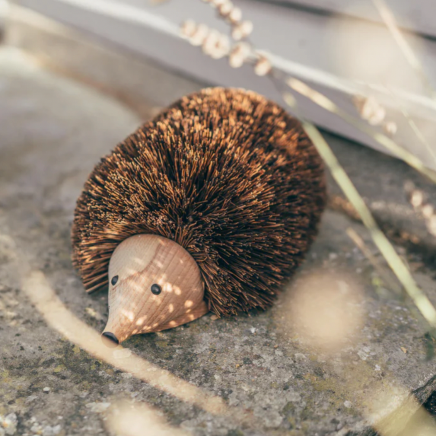 Redecker hedgehog shoe cleaner on display outside in garden