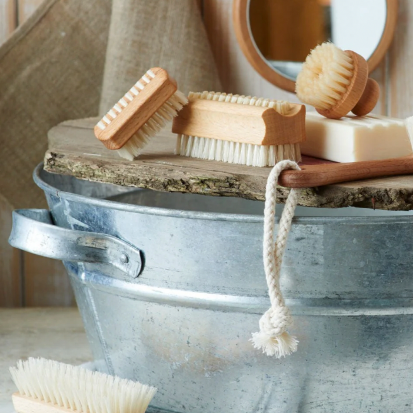 Redecker nail brush duo on display in bathroom with other Redecker cleaning tools