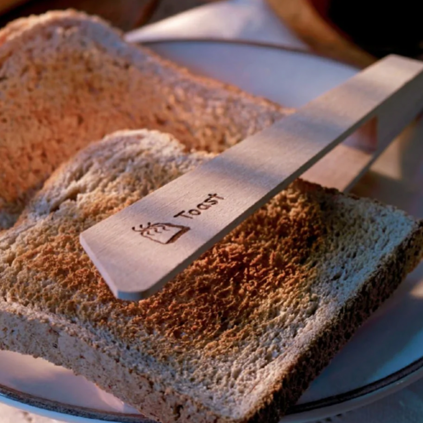 Redecker toast tongs on display clamping piece of toast