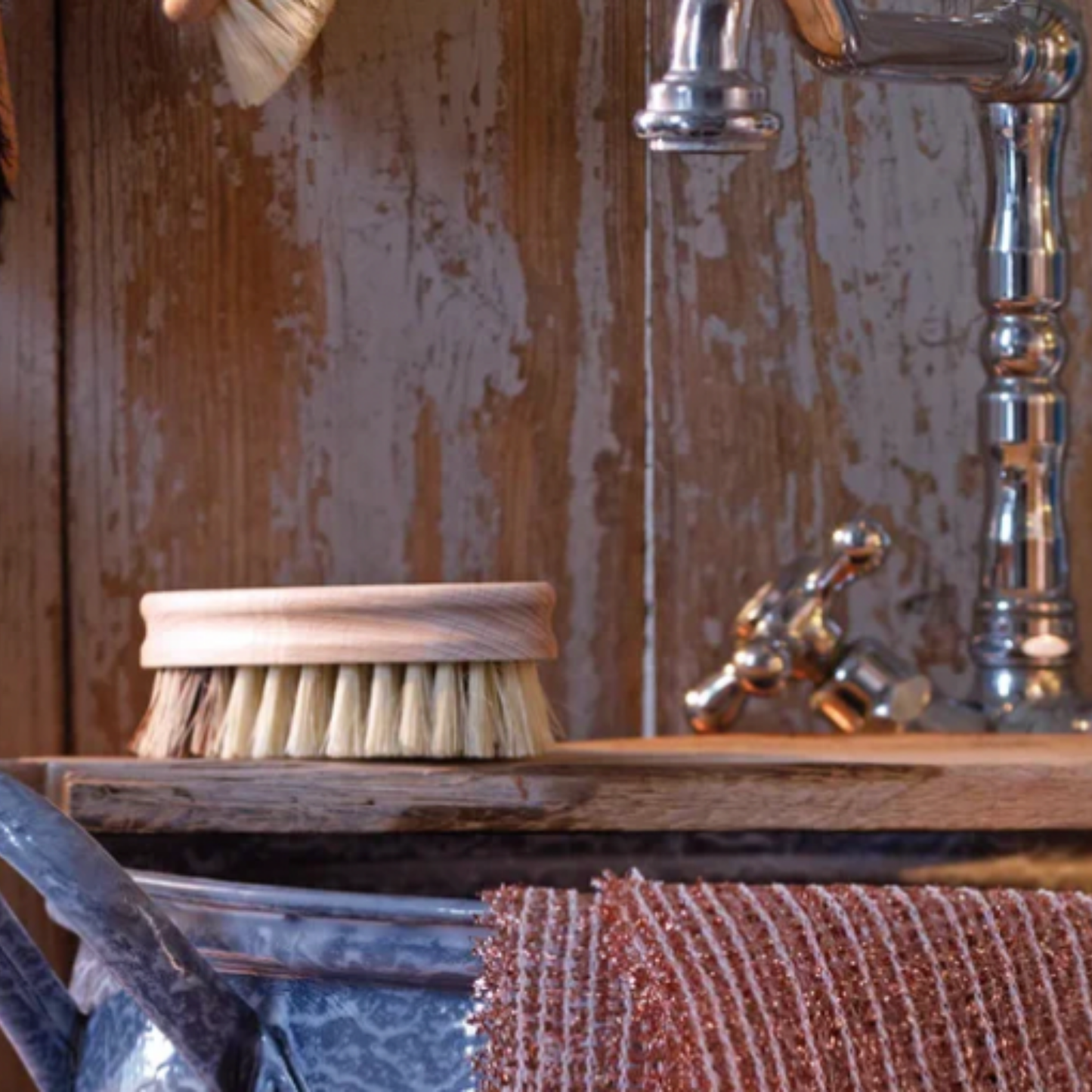 Redecker vegetable brush on display on wooden board in kitchen sink