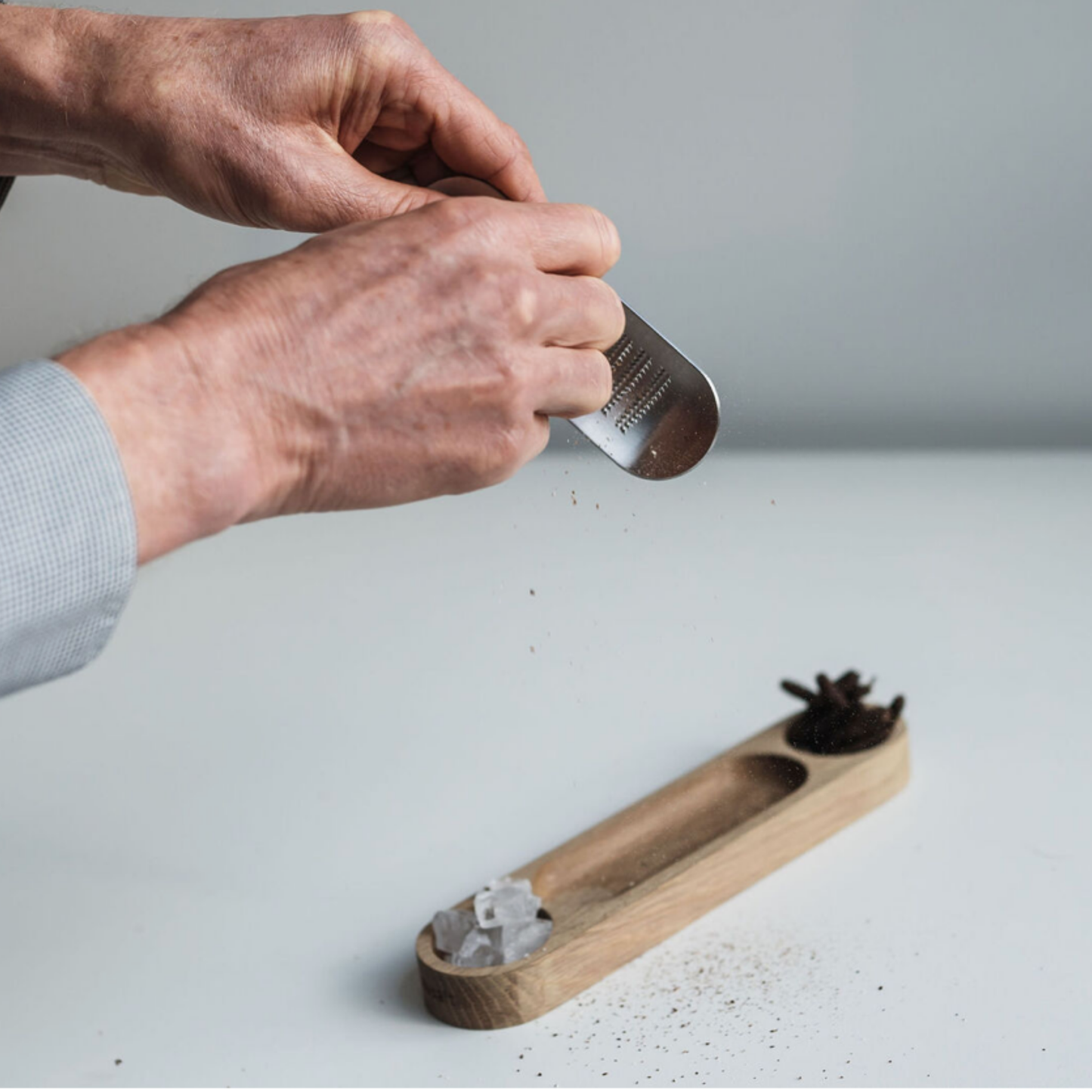 Man grating the pepper using Gift Box of Salt & Pepper Gourmet Tasters