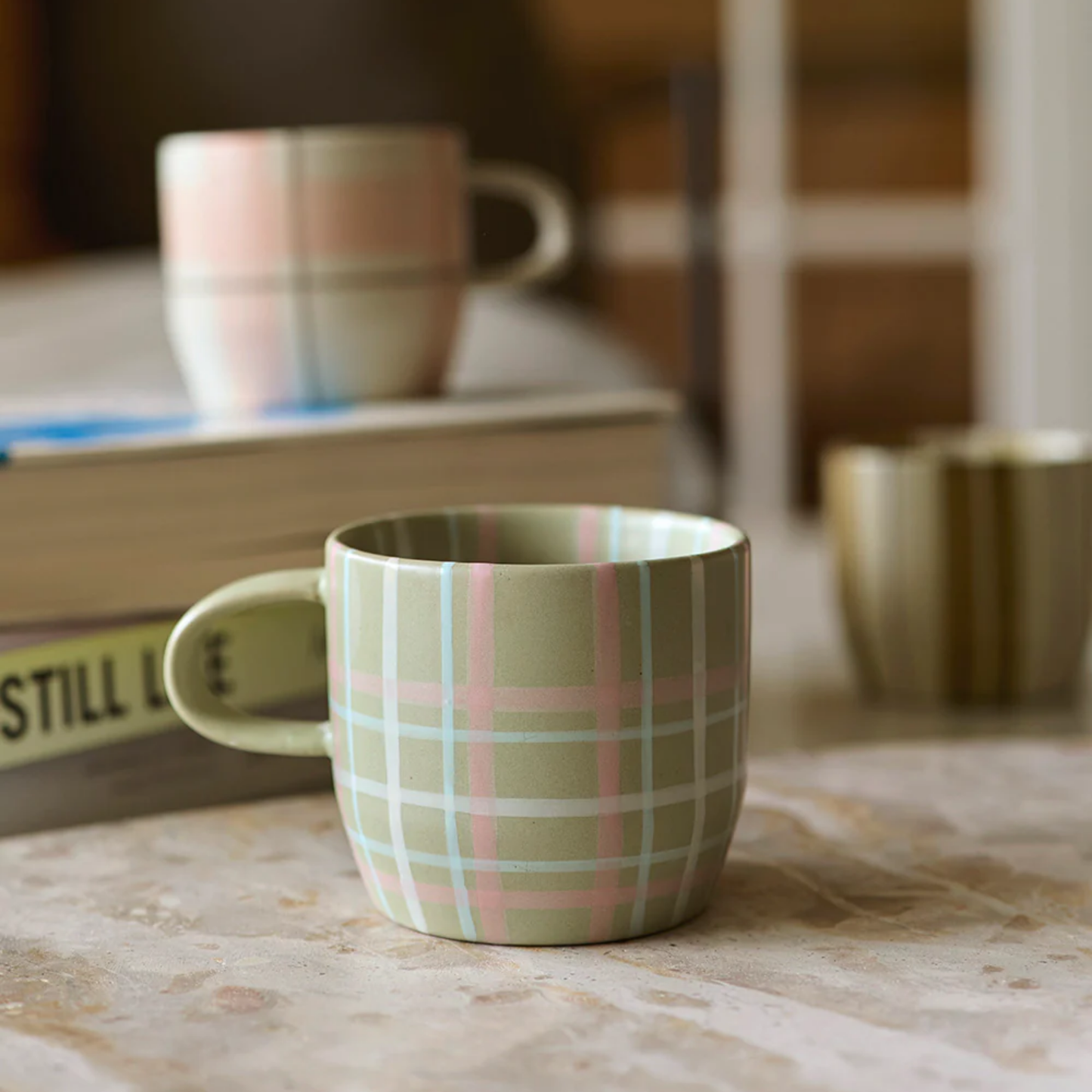 Robert Gordon cats pyjamas mug sage and blush on display on marble table with robert gordon muhgs in background