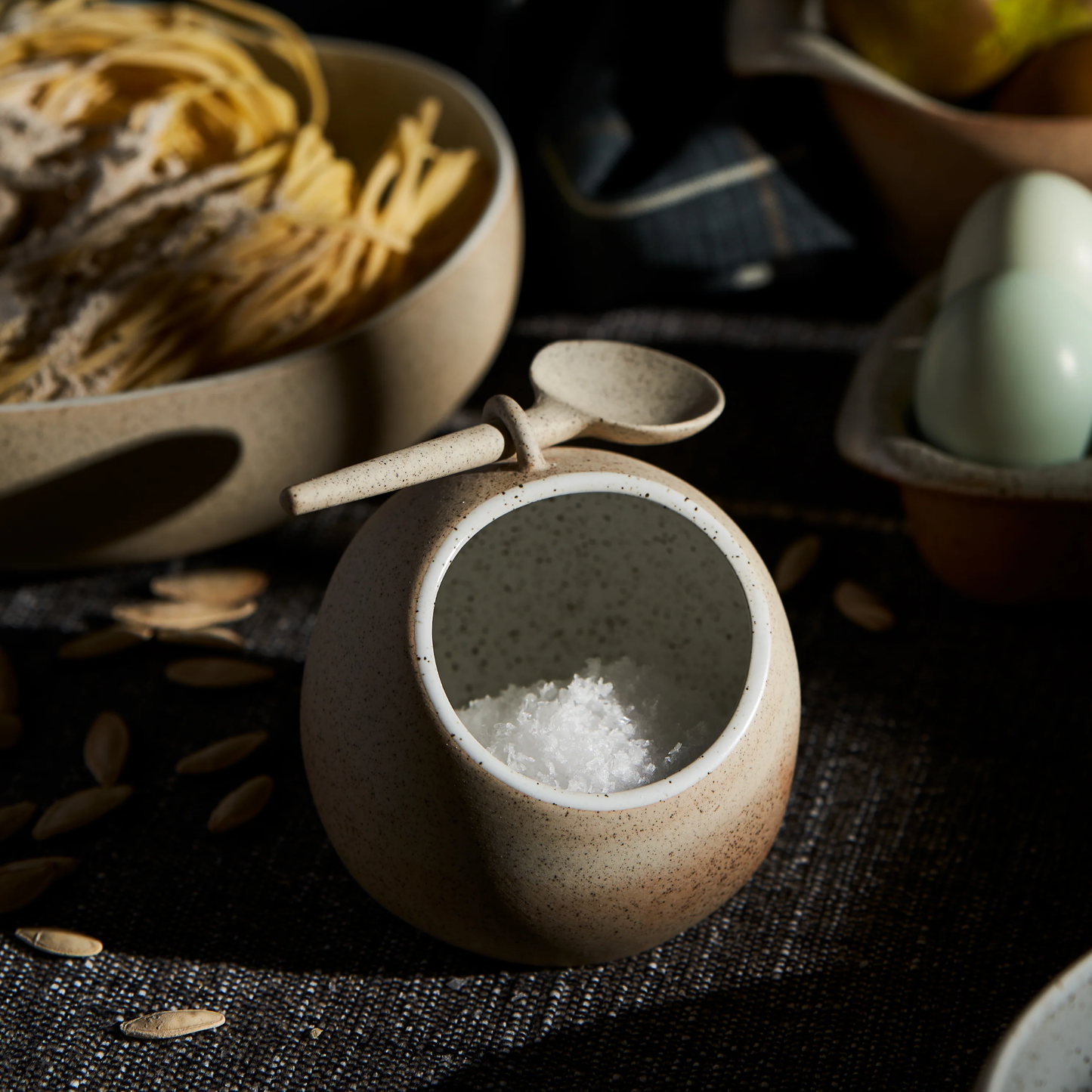 Robert Gordon salt pig with salt inside bowl and spoon in slot on top on display on table with food