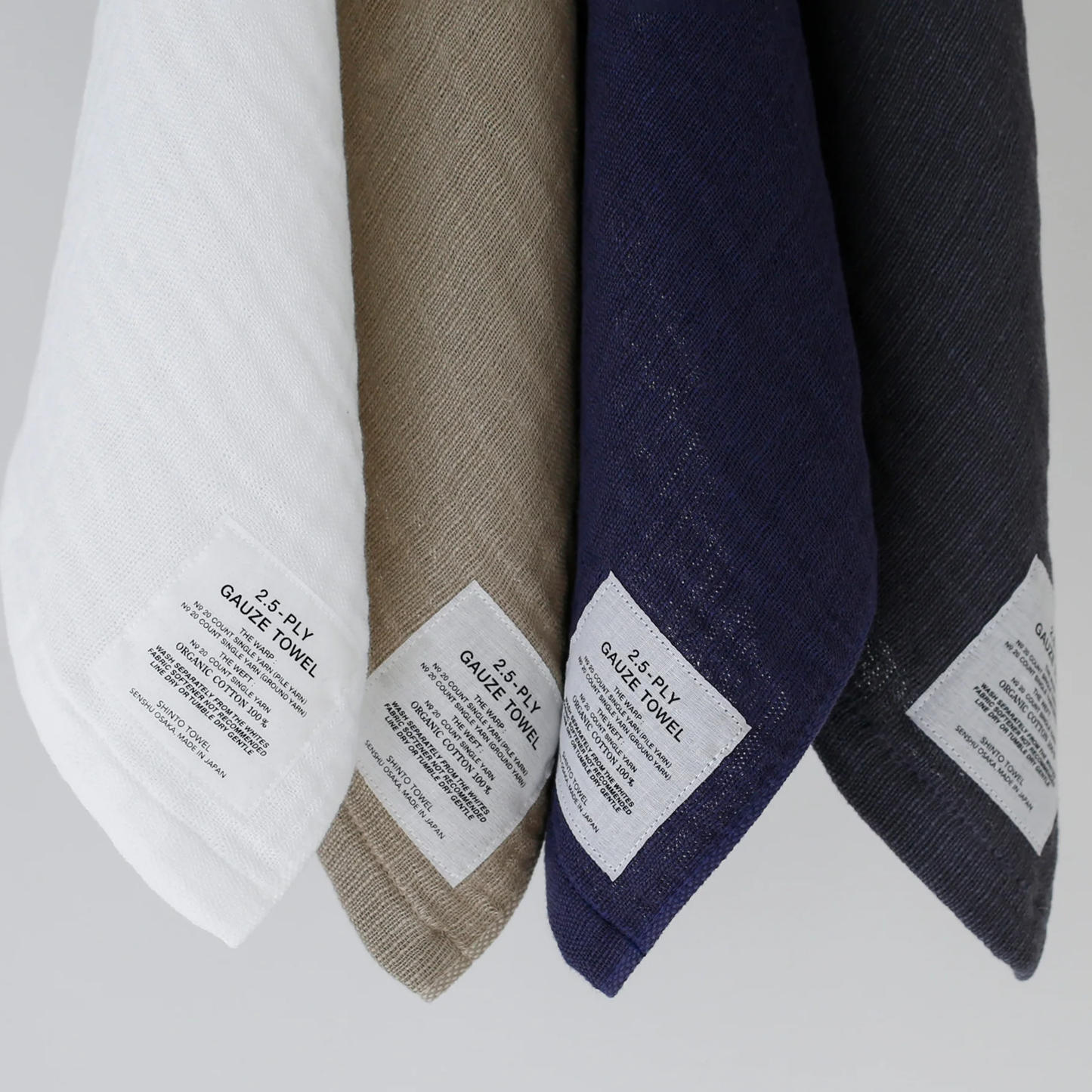 Close up of hung washcloths with Shinto 2.5-Ply Gauze Wash Cloth - Navy organic cotton towel, 30x34cm, lightweight and highly absorbent with soft layered weave for gentle, quick-drying comfort, made in Japan.