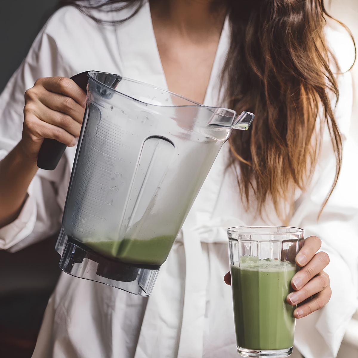 Pouring the matcha mixture from the blender to a glass, the Storm & India Matcha in Tin 30g Zen Matcha organic ceremonial grade, clean green caffeine.