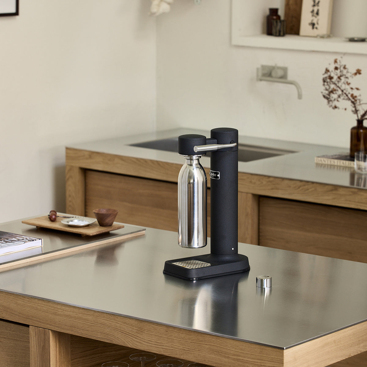 1000ml Stainlesss steel bottle attached to Black Carbonator 3 on kitchen bench