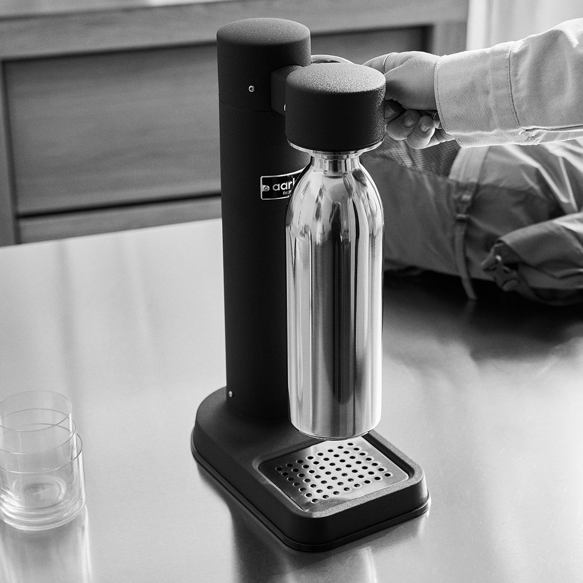 Close up of 1000ml Stainlesss steel bottle attached to Black Carbonator 3 on kitchen bench