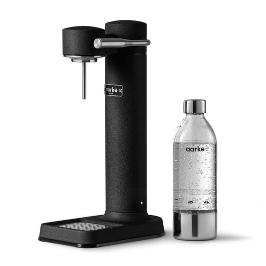 Stylish sparkling water maker designed by Aarke in Sweden showing the matte black finish and the included 650ml PET water bottle