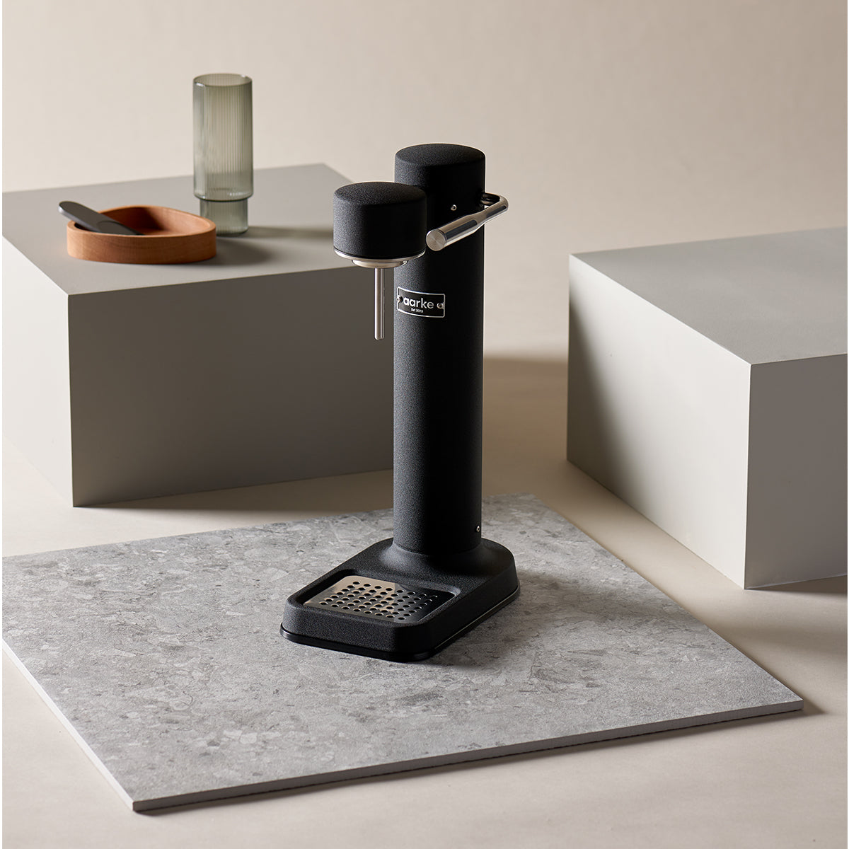 Stylish sparkling water maker designed by Aarke in Sweden showing the matte black finish and displayed on marble surface